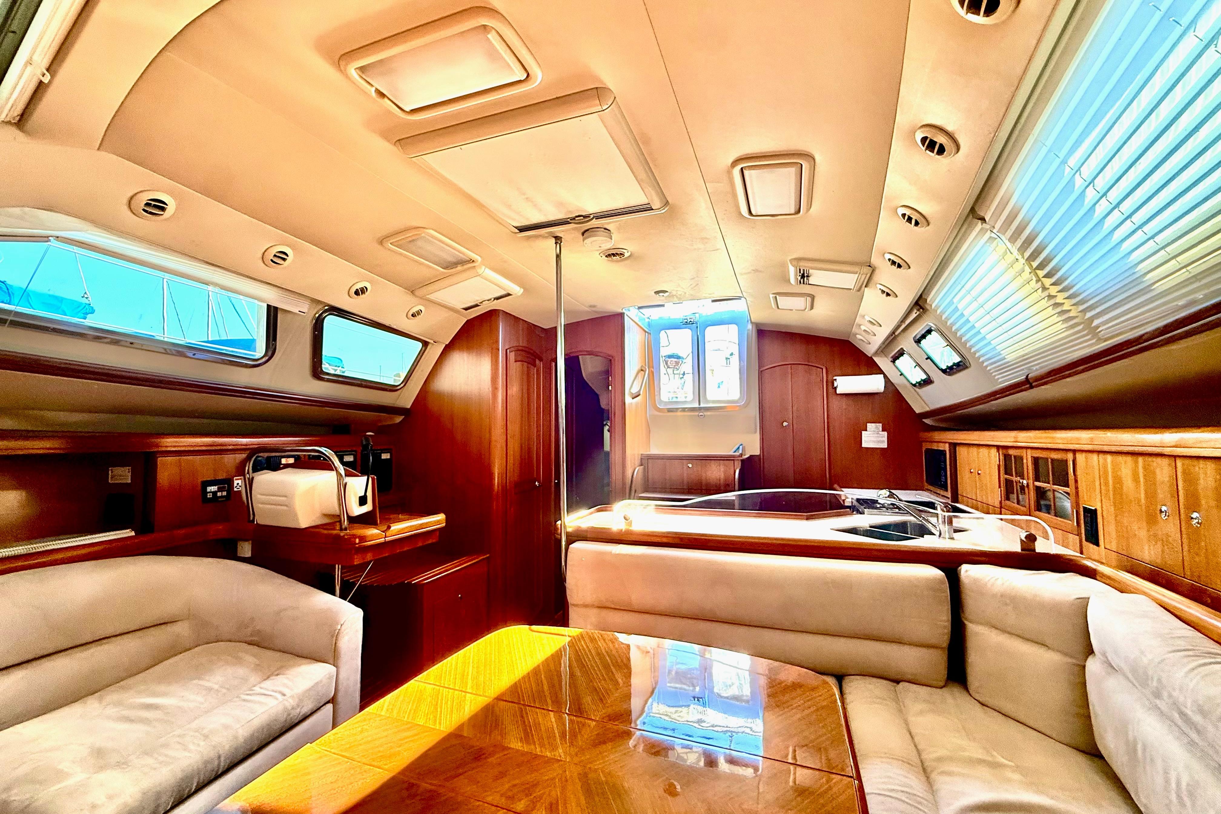 Luxurious interior of 2007 Hunter 41 Deck Salon yacht with elegant wood finishes.