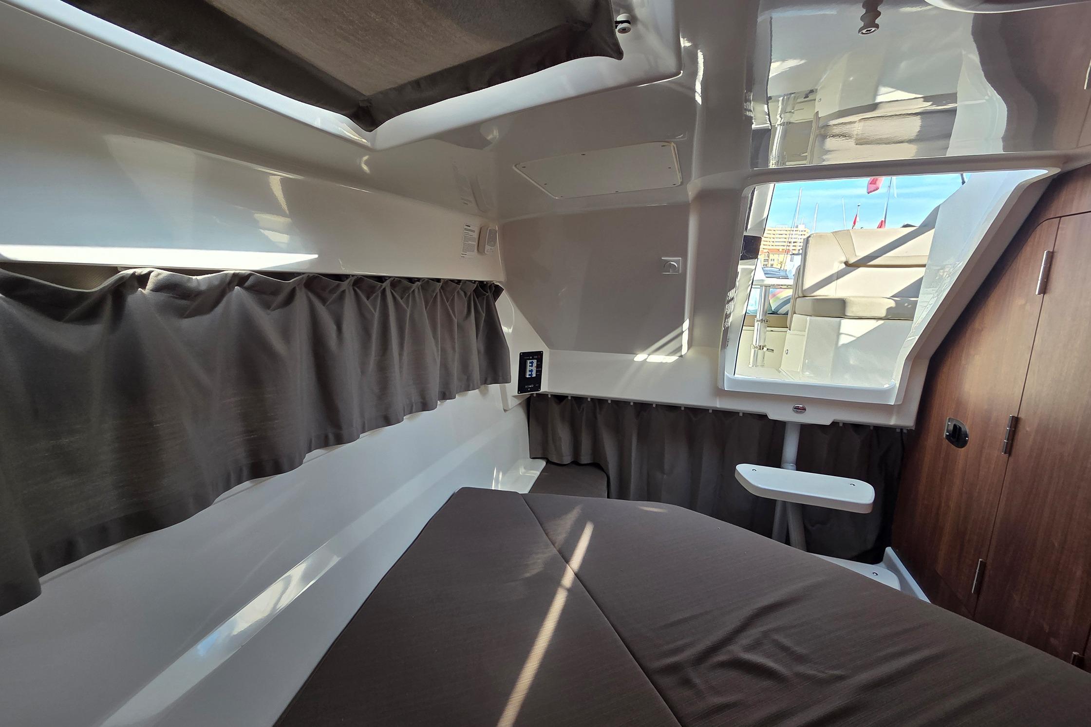 Interior cabin of 2017 Quicksilver Activ 805 Cruiser with bed and window view.