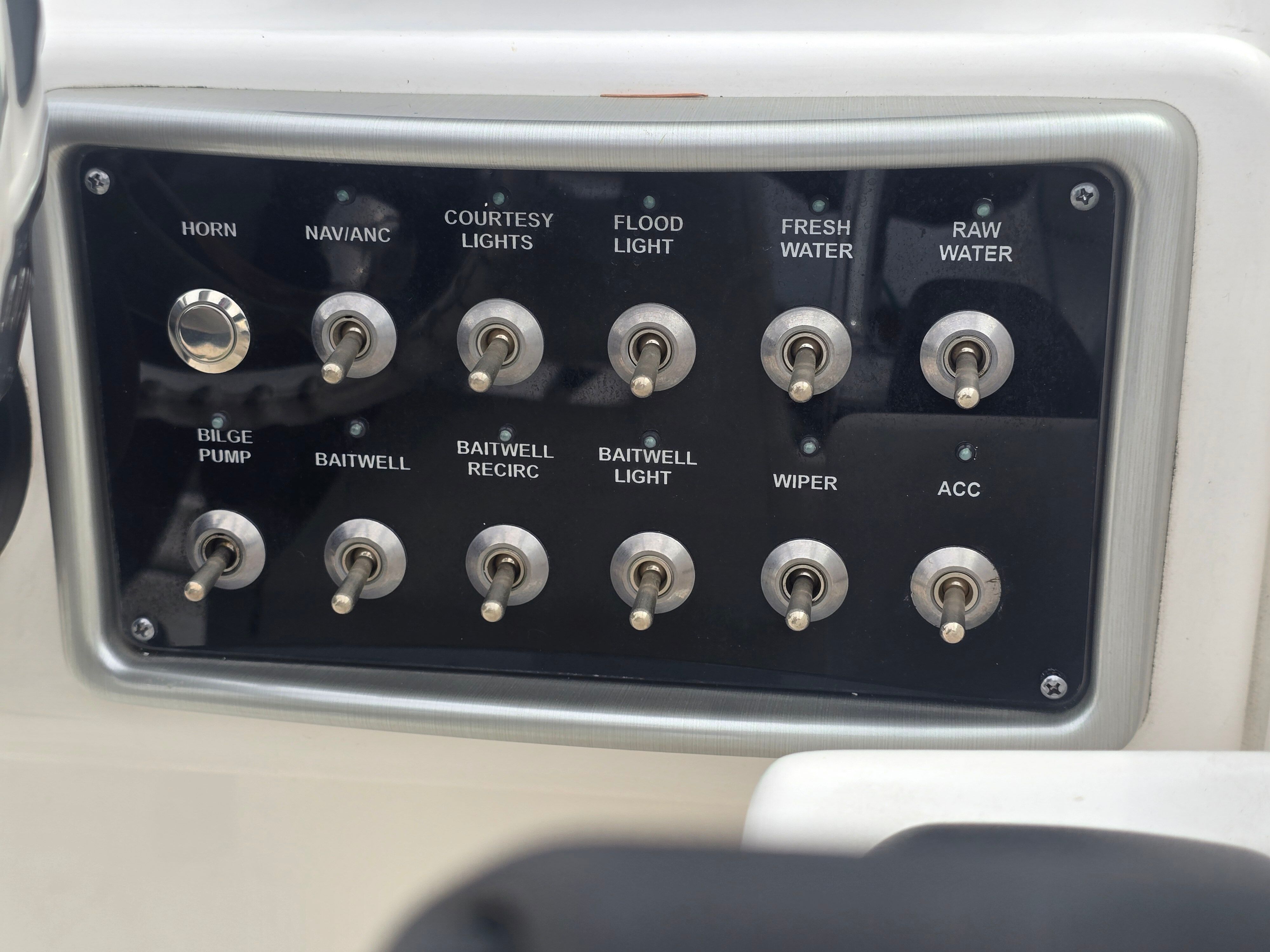 Control panel with various switches for boat functions.