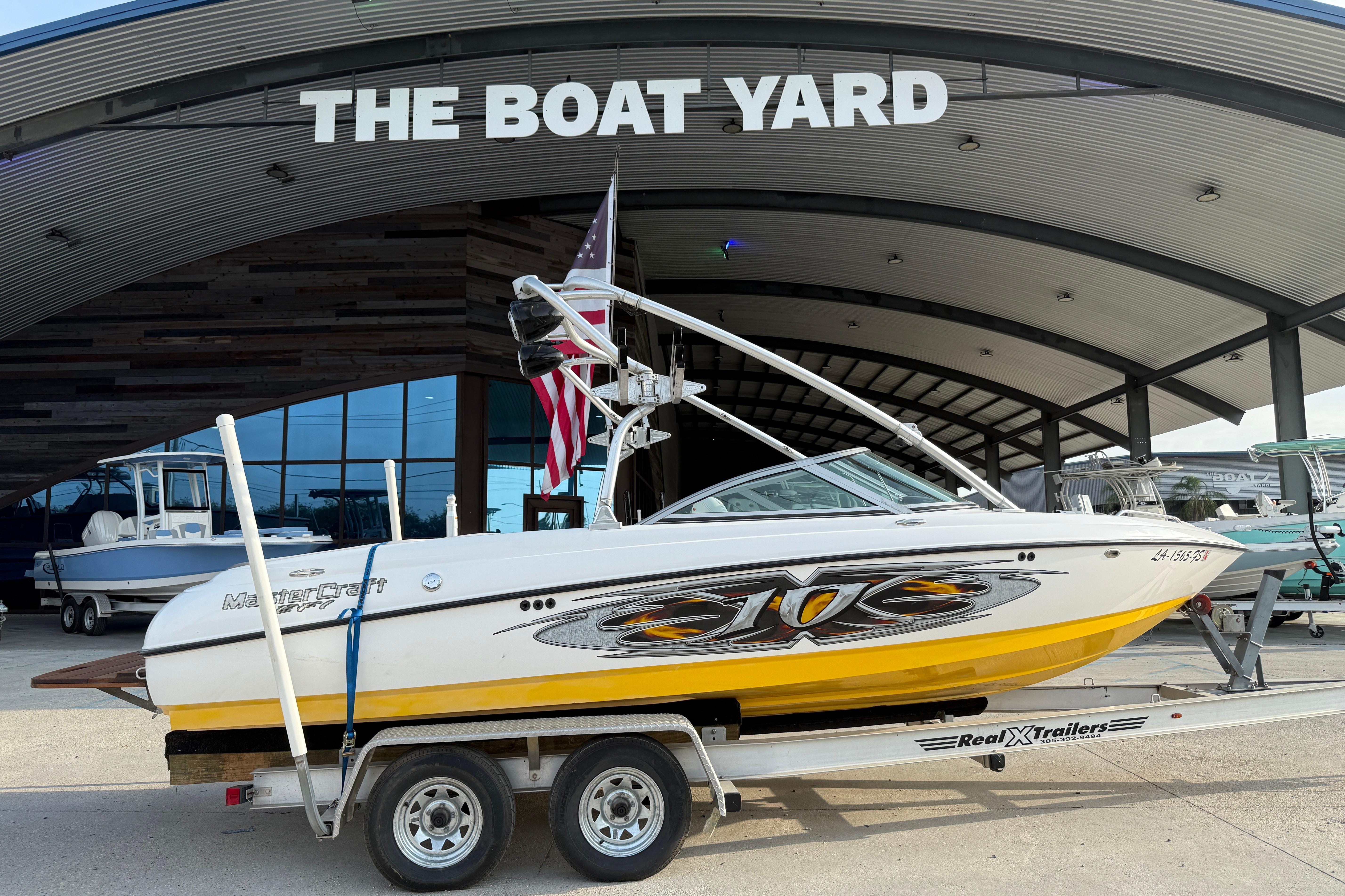 2005 MasterCraft X10 boat on trailer at The Boat Yard dealership.