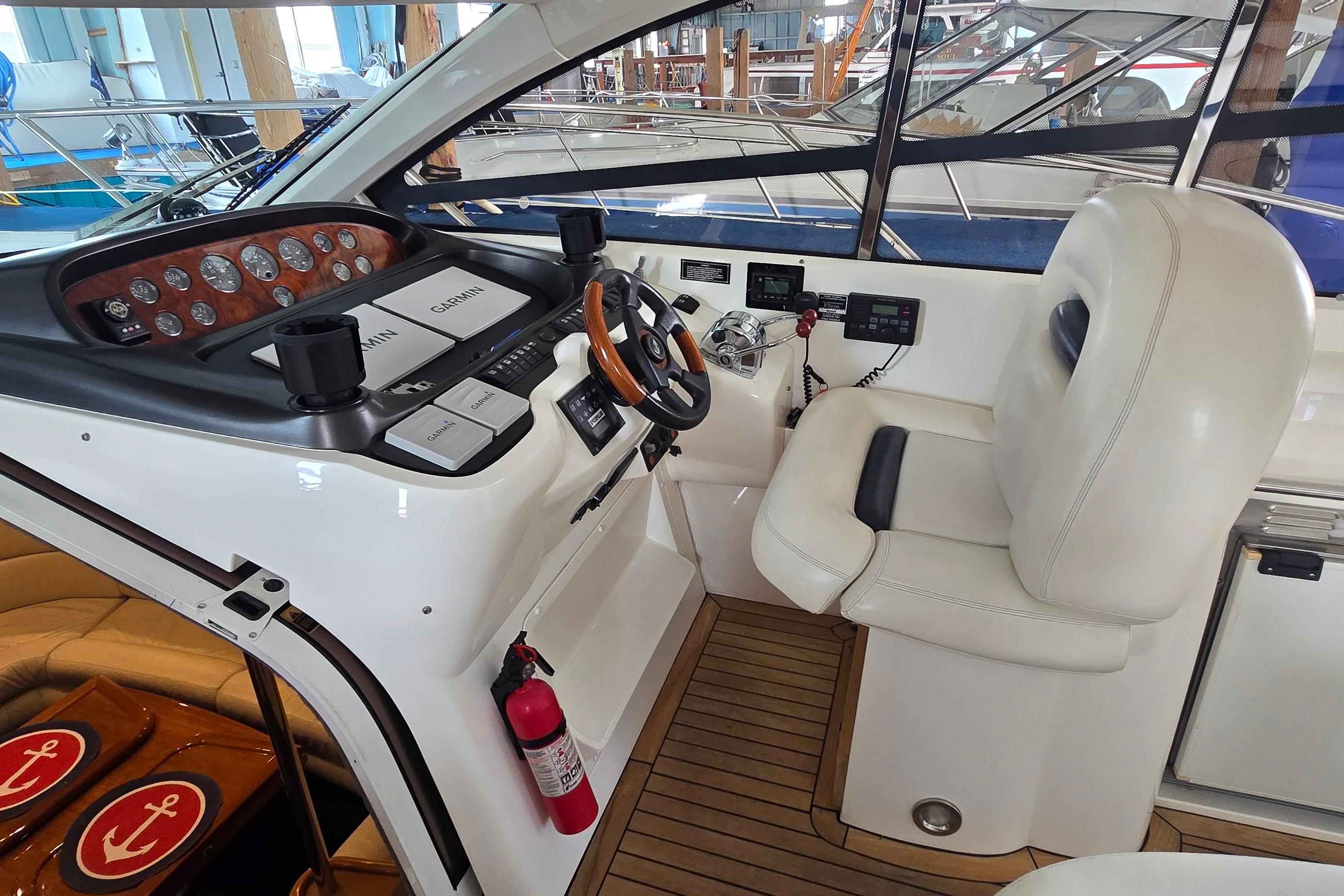 Helm of 2004 Sunseeker Camargue 50 yacht with Garmin navigation and luxurious seating.
