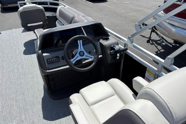 2026 Sun Tracker Fishin' Barge 20 DLX interior with steering wheel and seating.