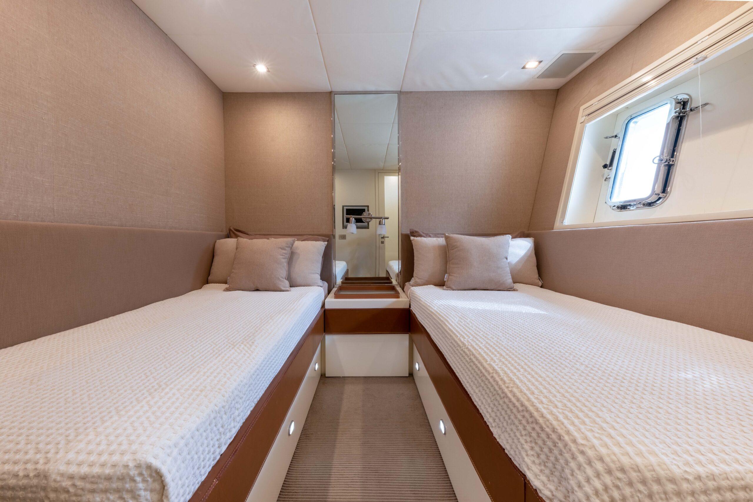 Luxurious twin cabin interior of 2006 Mangusta 80 yacht with modern decor.