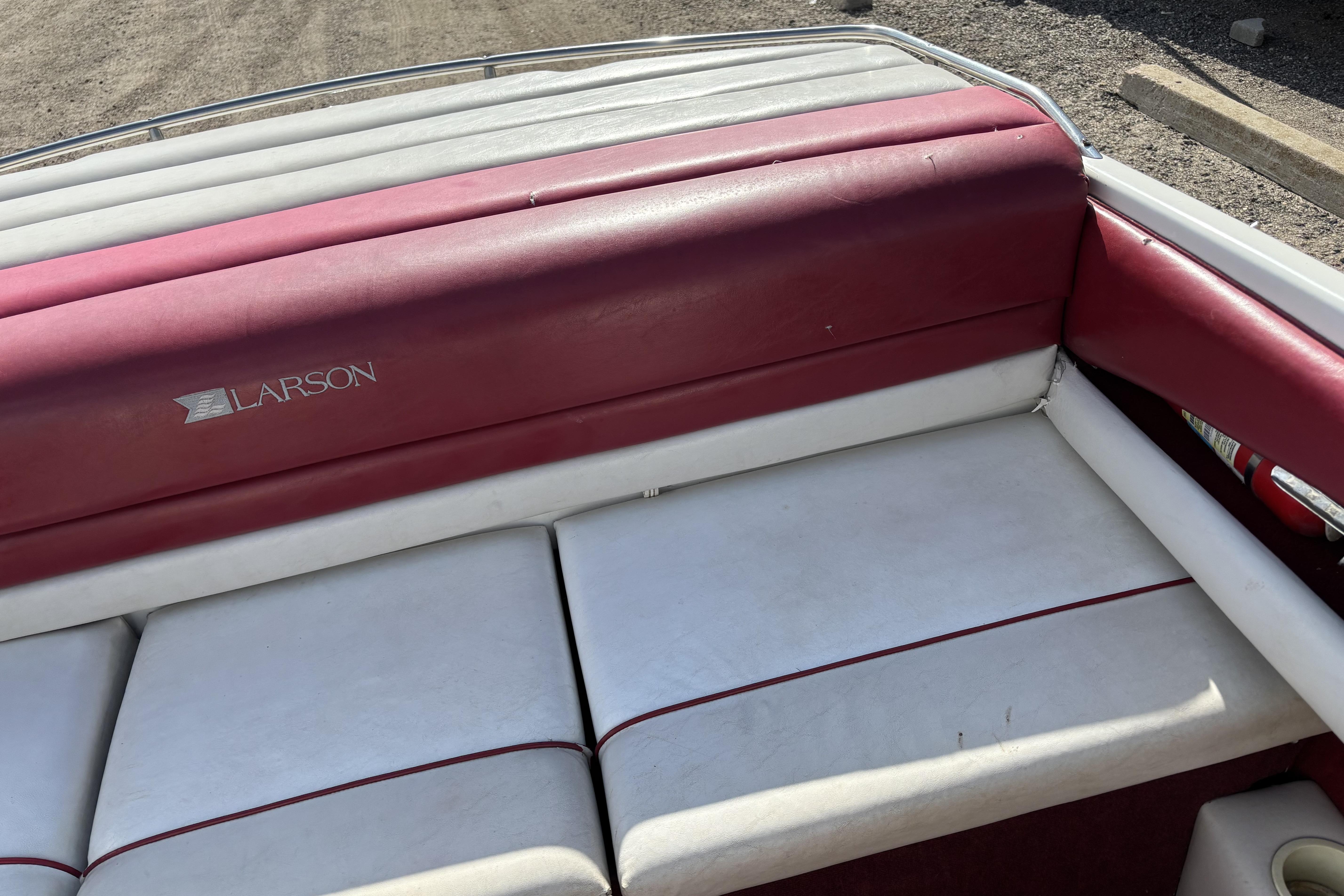 Red and white interior of a 1993 Larson SEi 200 Cuddy I/O boat.