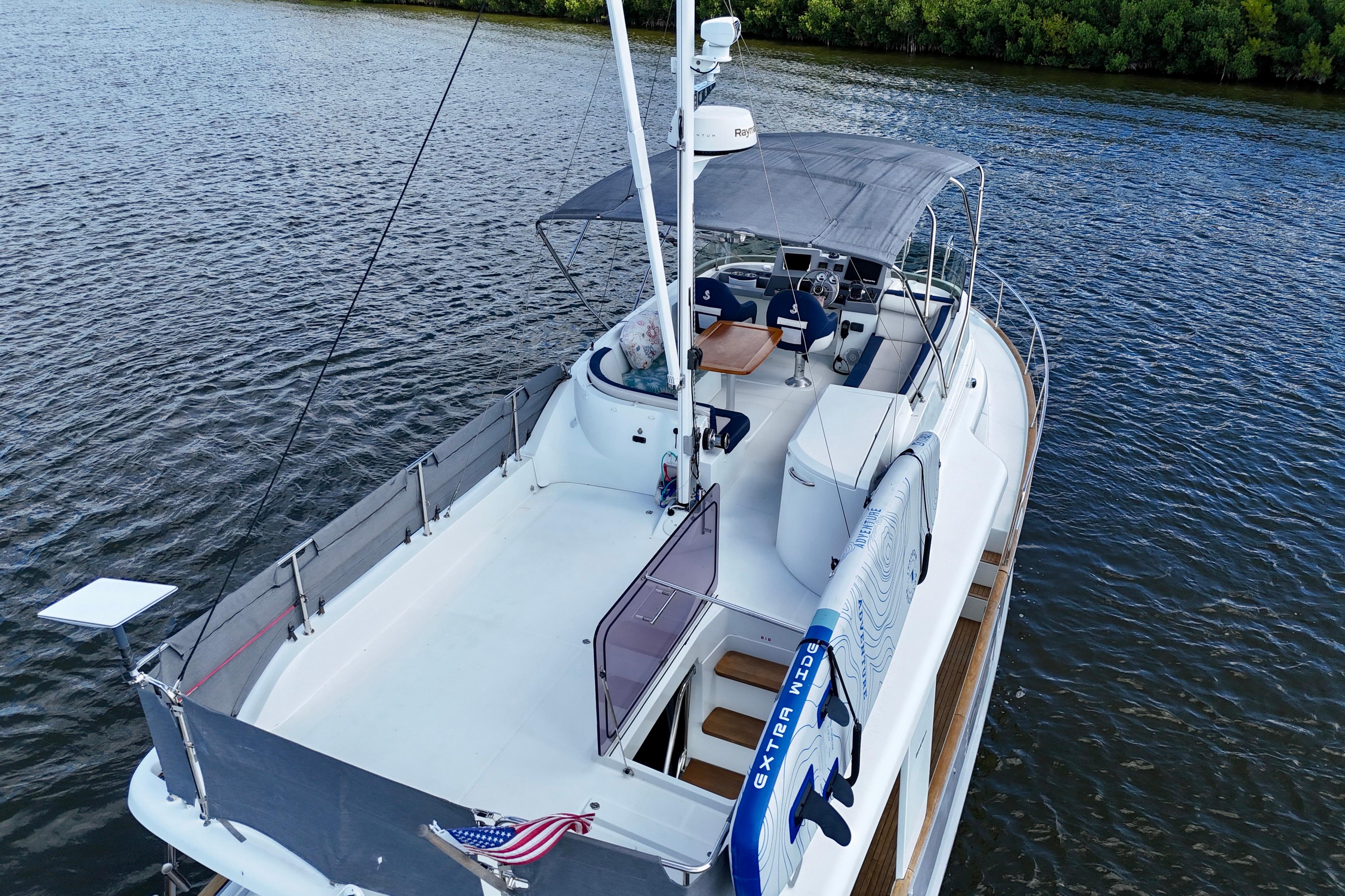 2020 Beneteau Swift Trawler 44 on water, featuring spacious deck and canopy.