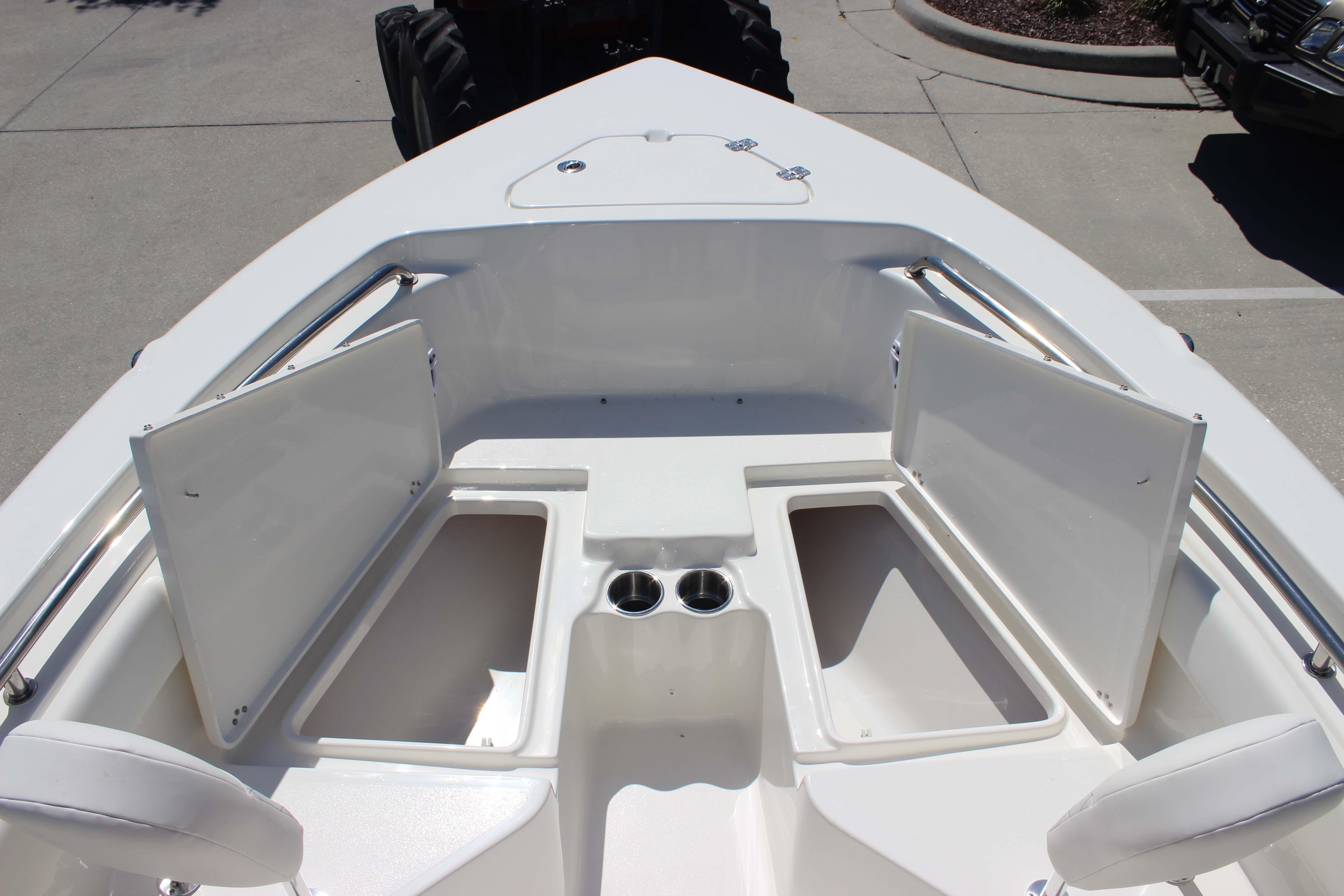 Bow seating area of 2026 Key West 203 FS boat with storage compartments open.