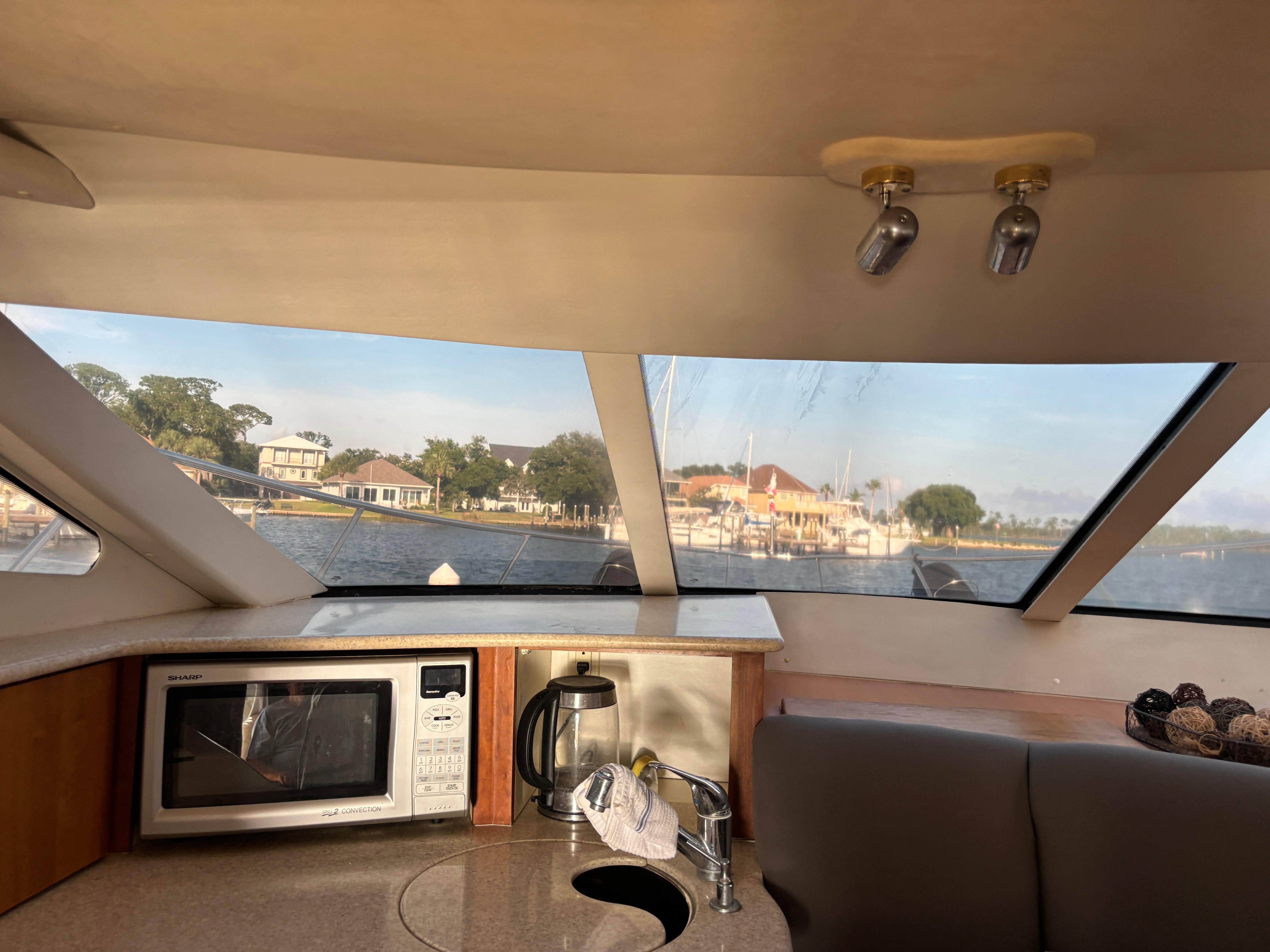 Interior view of 2001 Silverton 410 Sport Bridge with kitchen amenities and scenic window view.