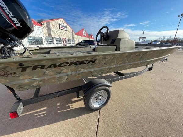 2024 Tracker Grizzly 1648 SC boat on a trailer outside dealership.