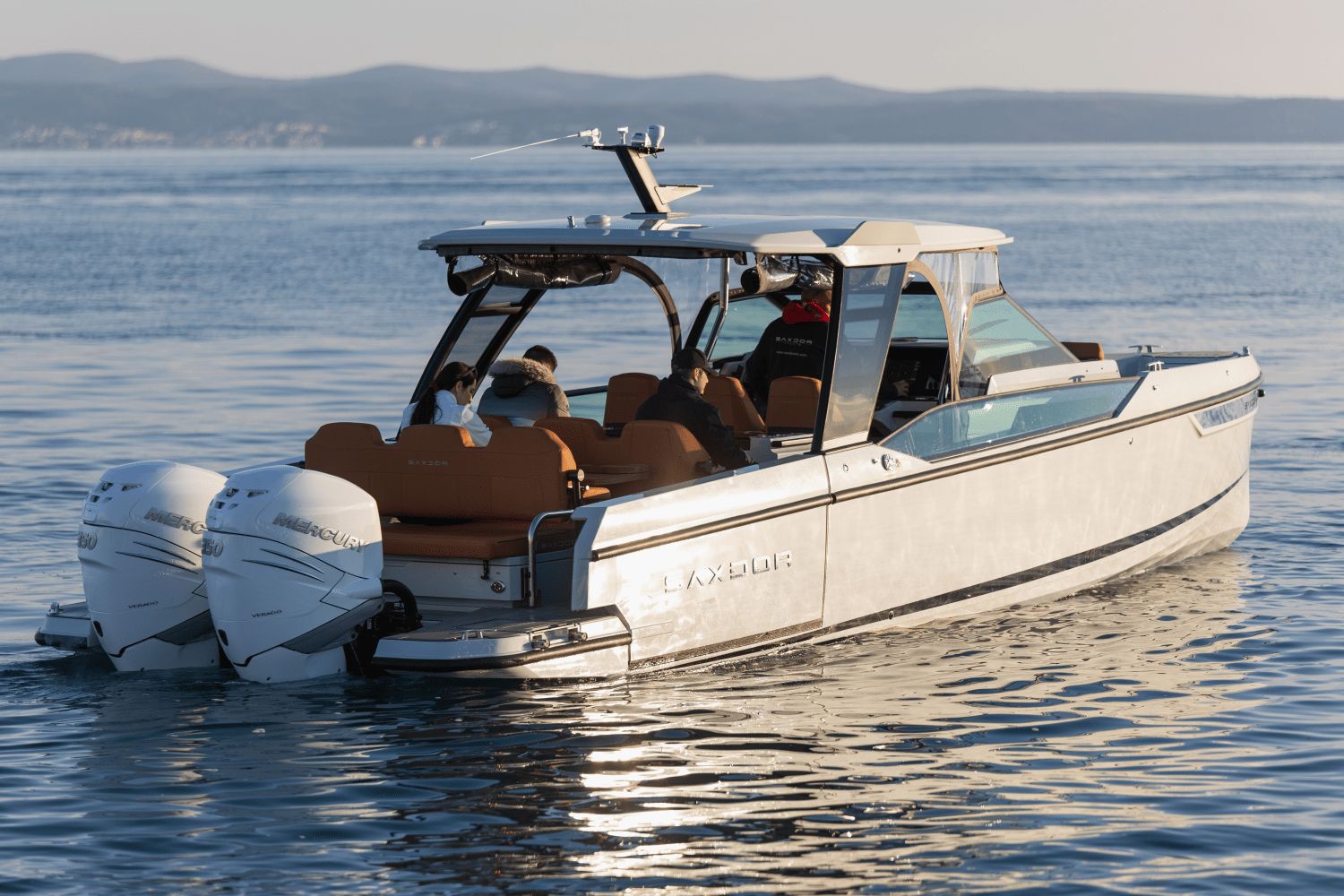 A 2027 Saxdor SX320 GTO cruising on calm waters.
