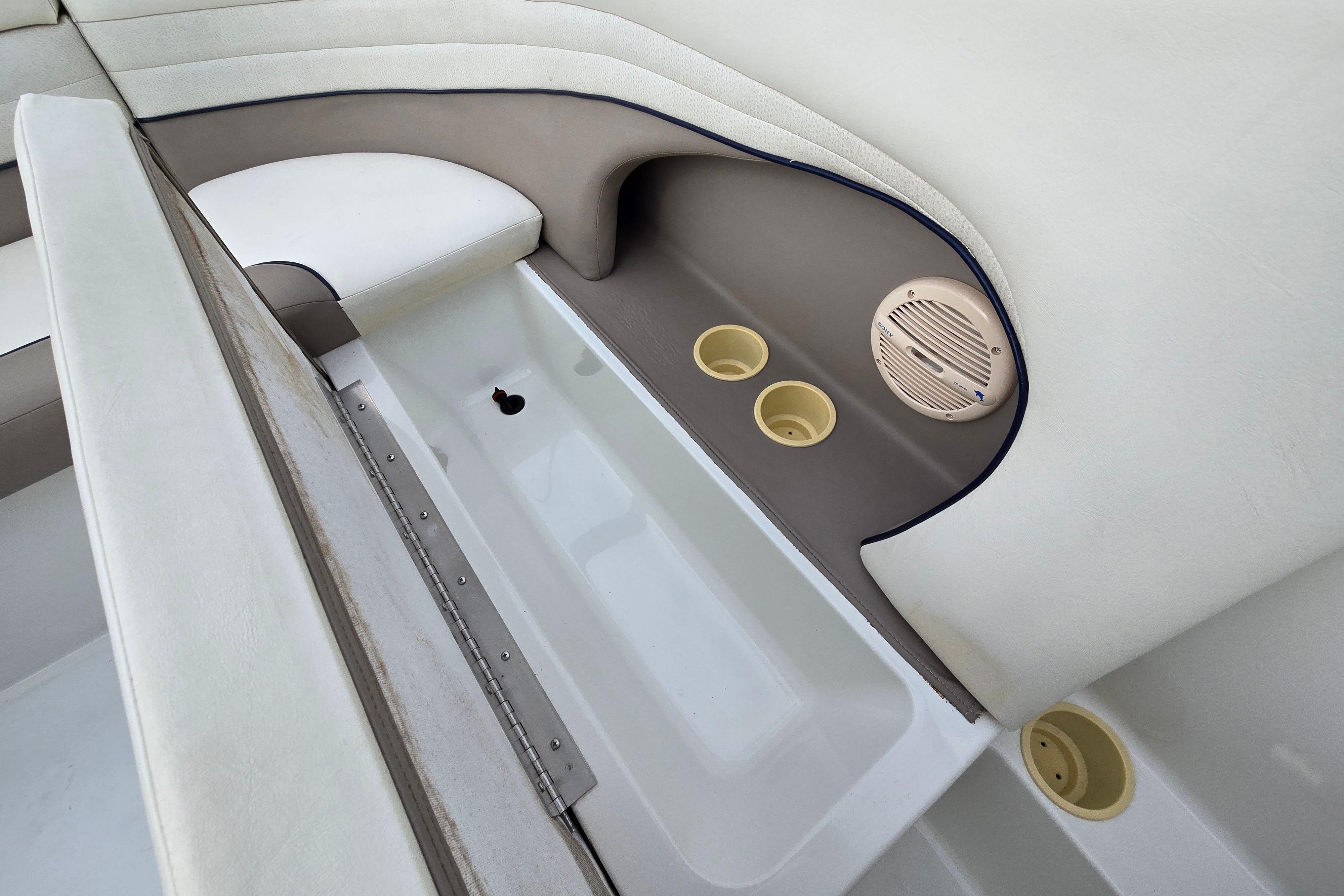Interior of a 2000 Cobalt 246 boat featuring seating, cup holders, and speaker.