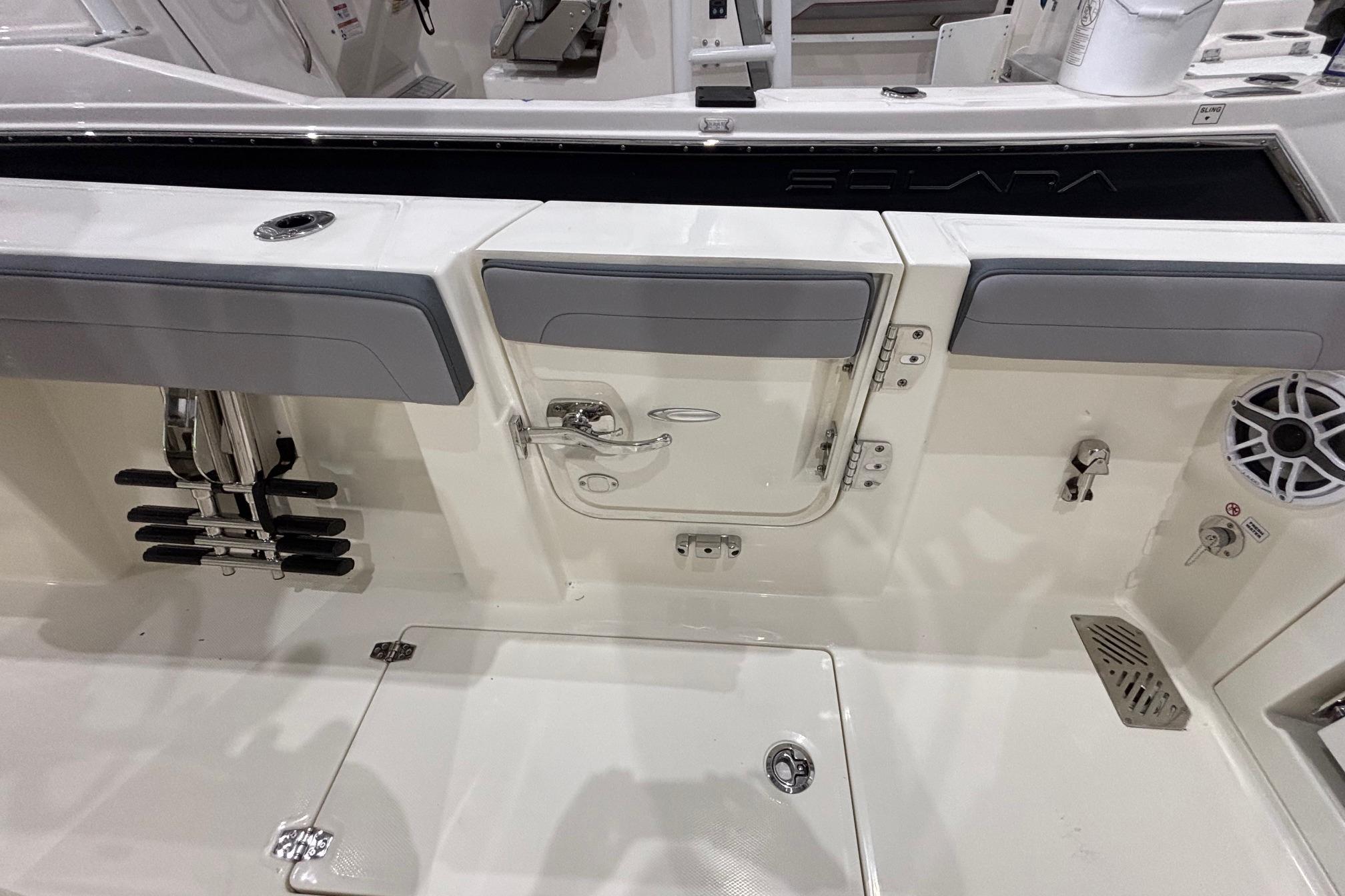 2026 Cobia 285 Open Center Console boat interior with storage compartments and speaker.