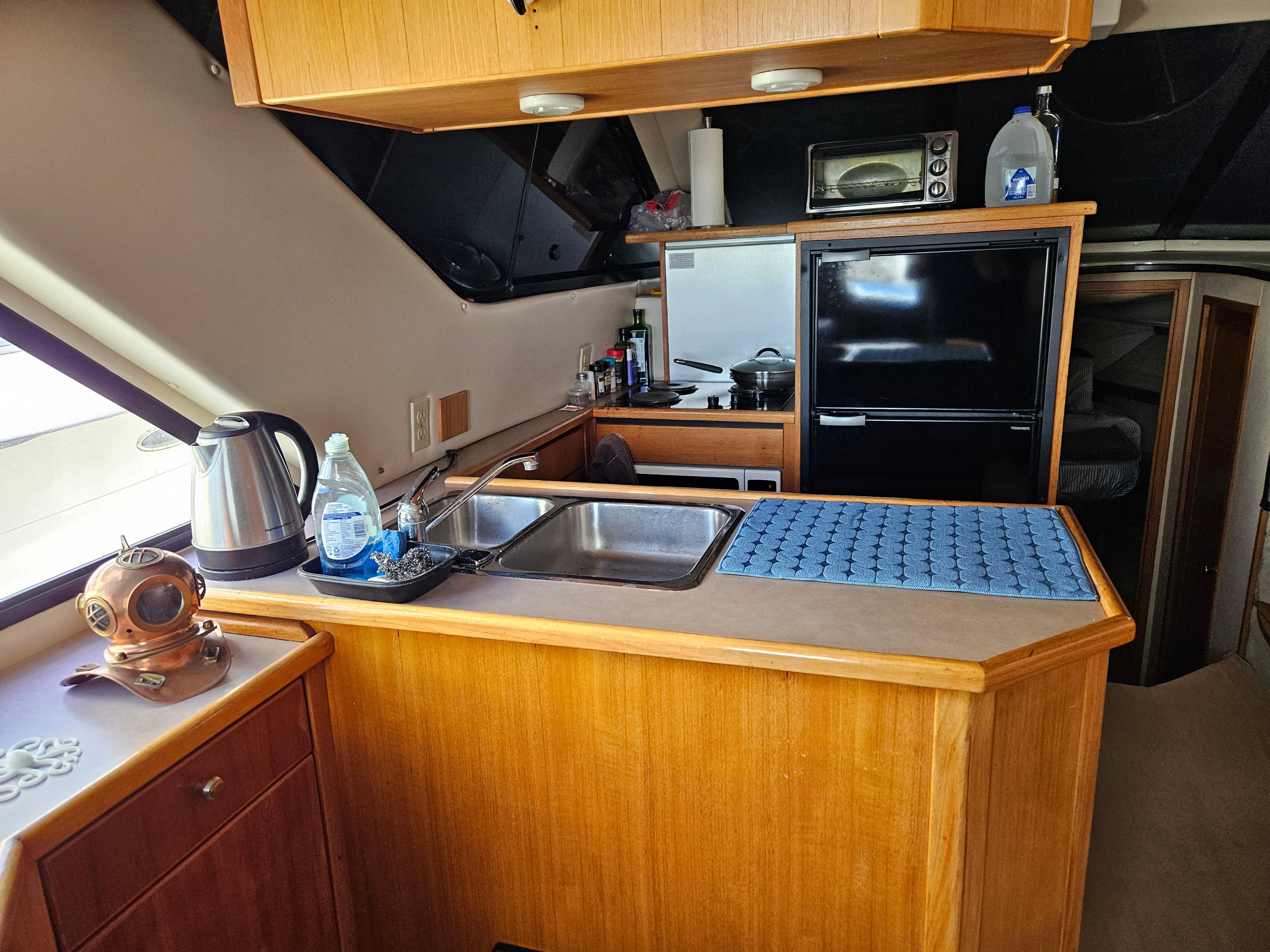 1997 Bayliner 3788 Command Bridge Motoryacht kitchen with sink, fridge, and appliances.