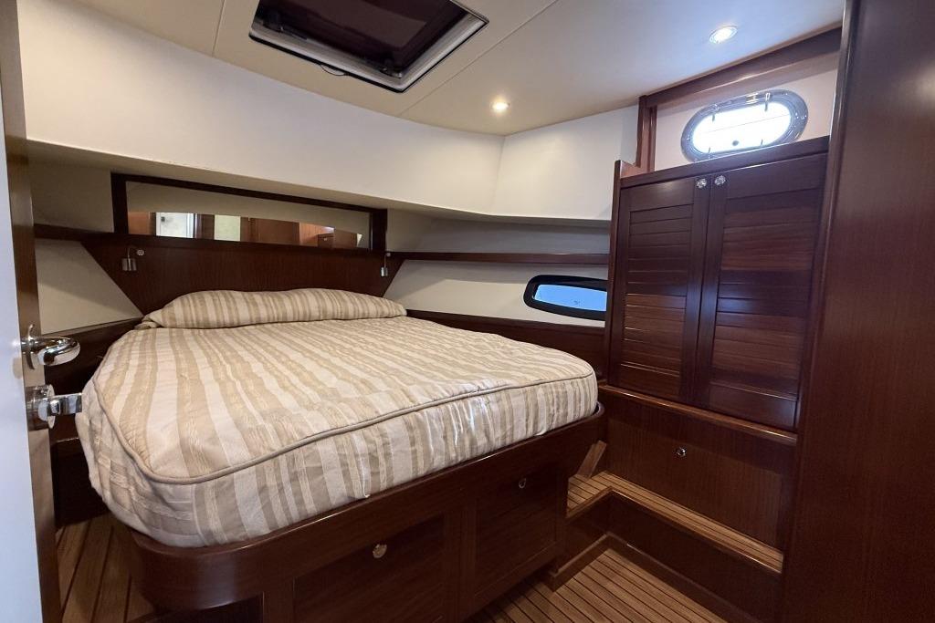 Luxurious cabin interior of 2012 Sasga Yachts Menorquin 42 with wooden finishes.