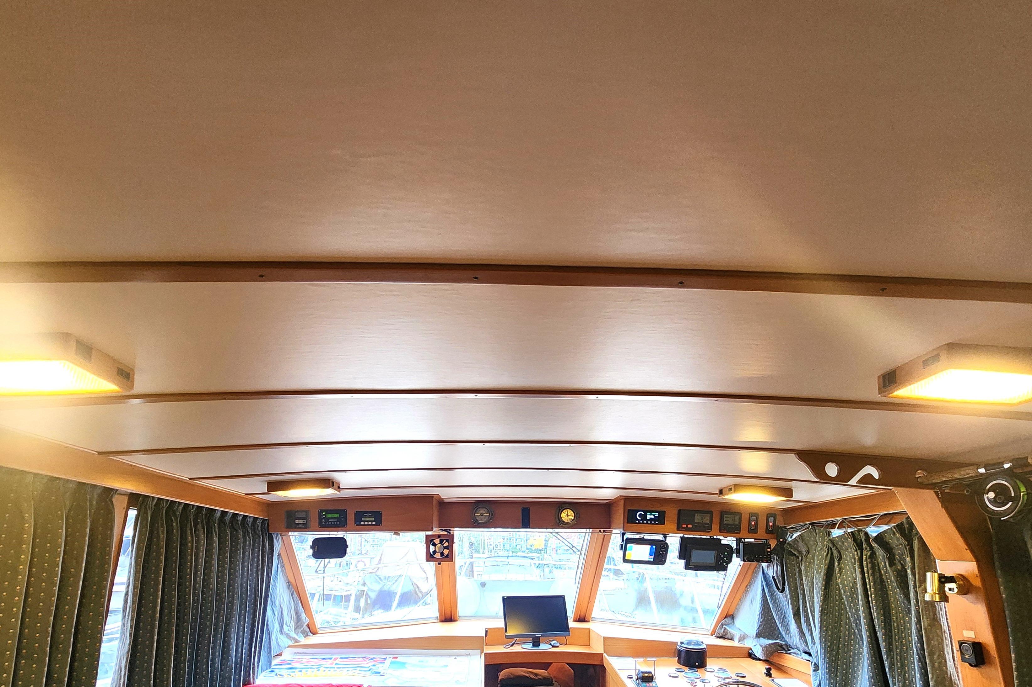 Interior of 1991 Roughwater Sportfish boat with navigation equipment and wooden ceiling.