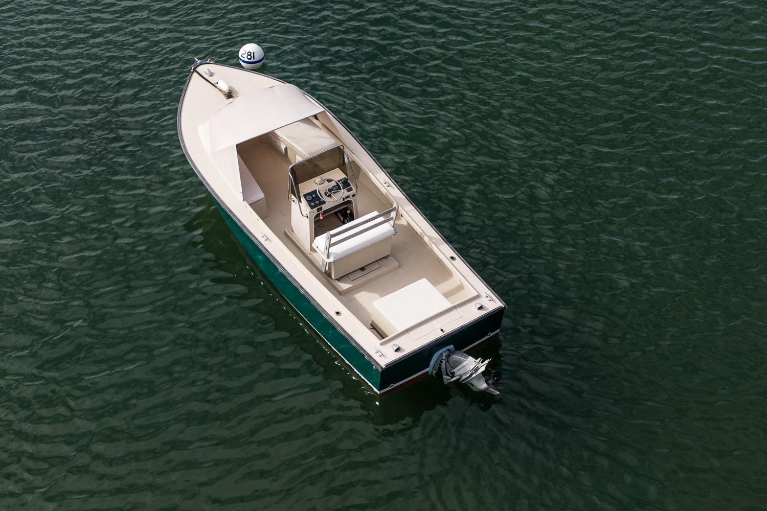 1989 Ellis 24 Open boat on calm water, aerial view.