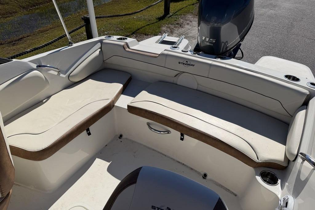 2024 Stingray 191 DC boat interior with cushioned seating and motor view.