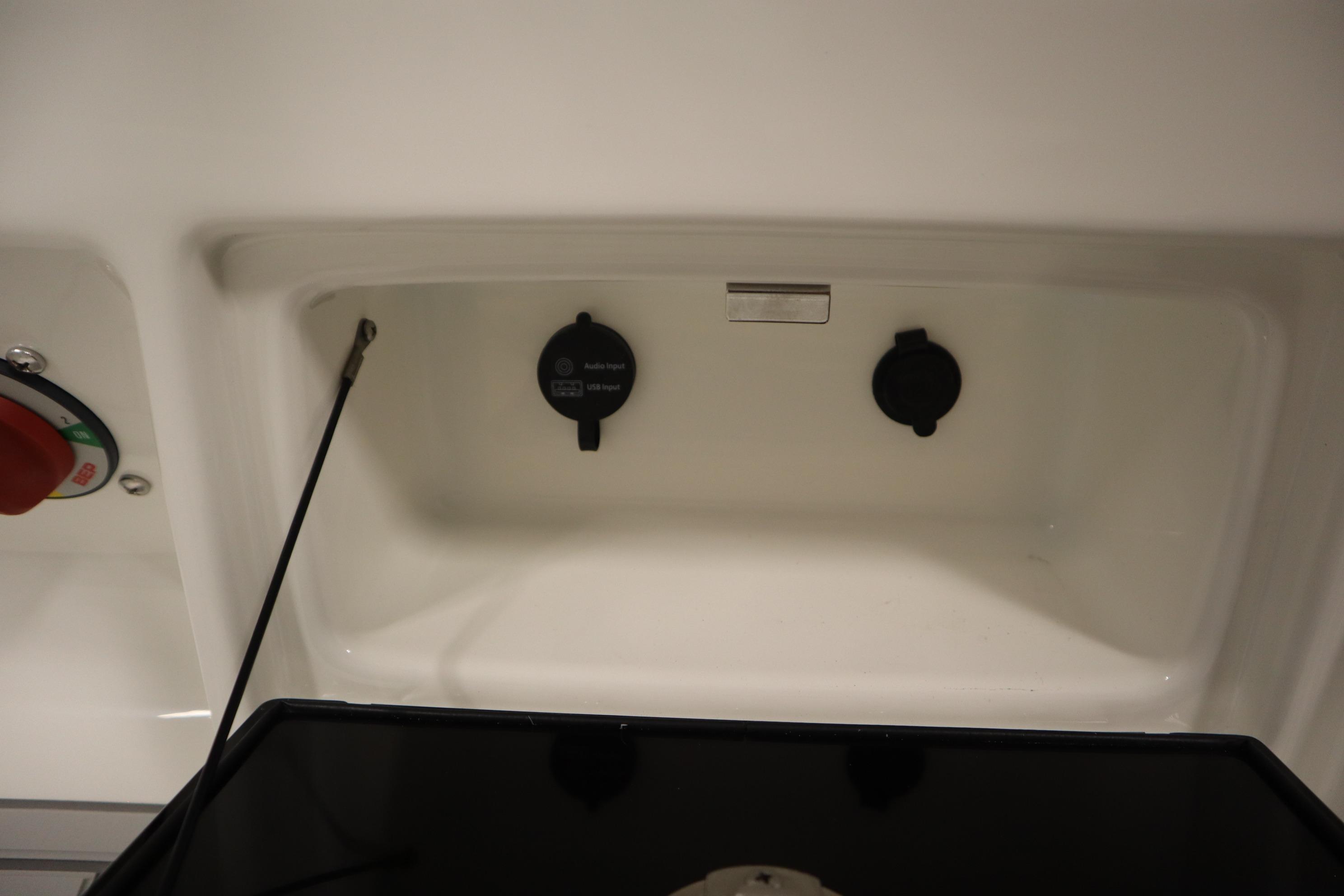 2026 Sea Fox 228 Commander boat interior compartment with audio input and control panel.