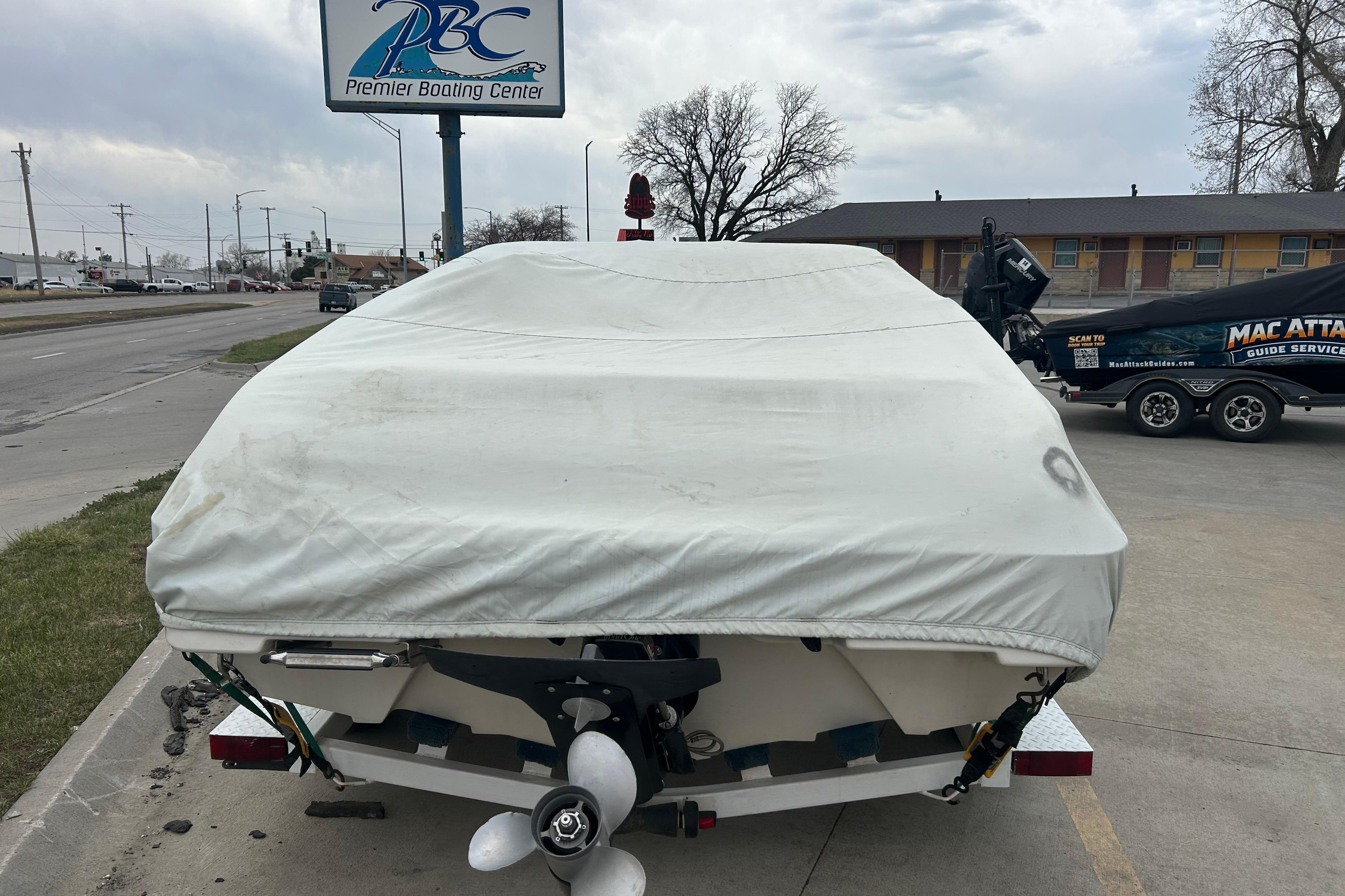 Covered 1996 Mariah 180 Shabah boat at Premier Boating Center parking lot.