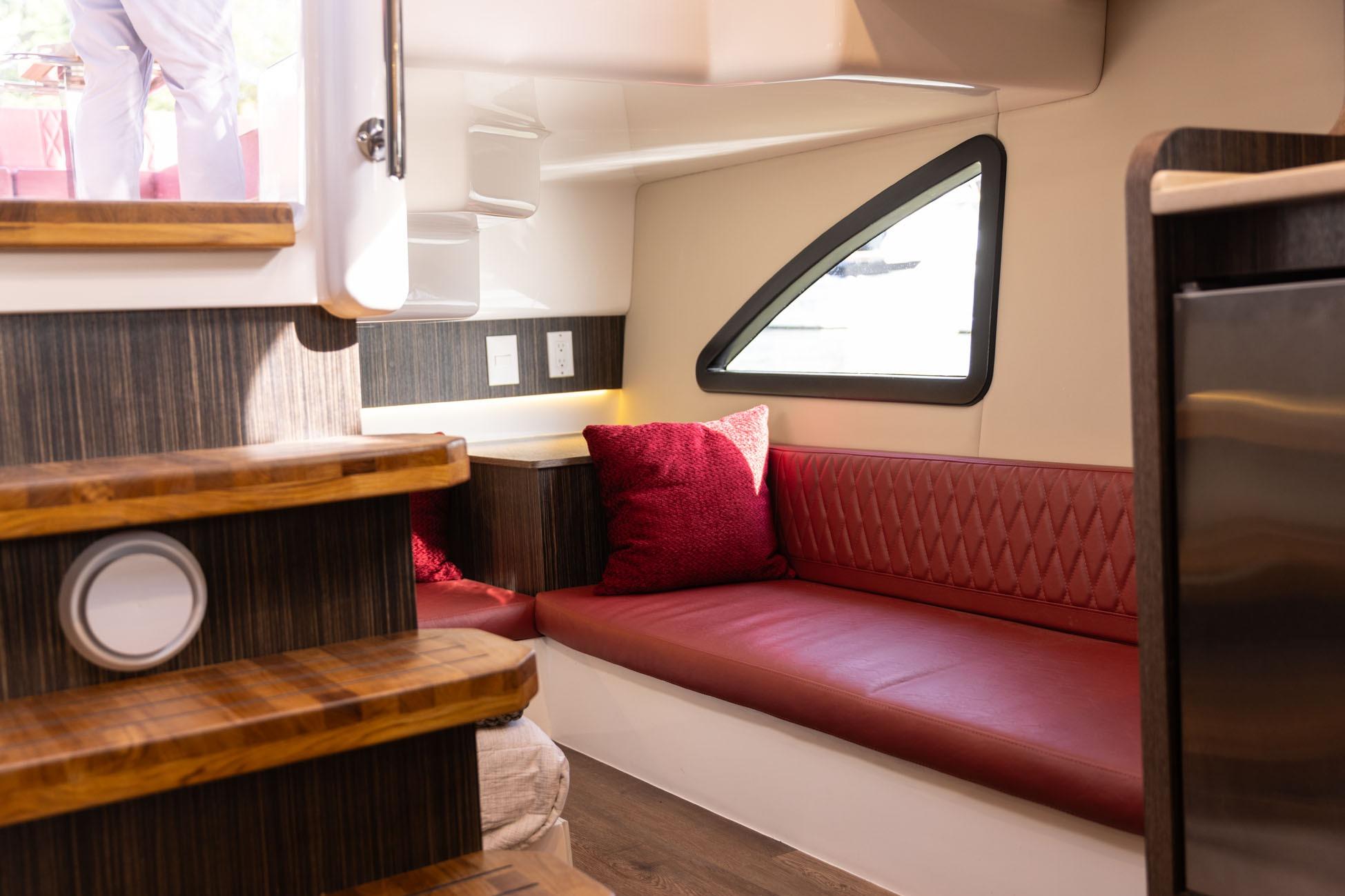 Luxurious interior of 2026 Hanover 387 yacht with red seating and modern design.