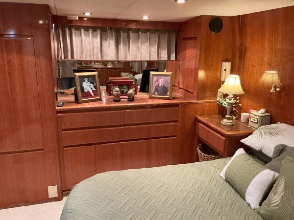 Luxurious bedroom interior of 2000 Novatec Islander 55 yacht with wood paneling and decor.