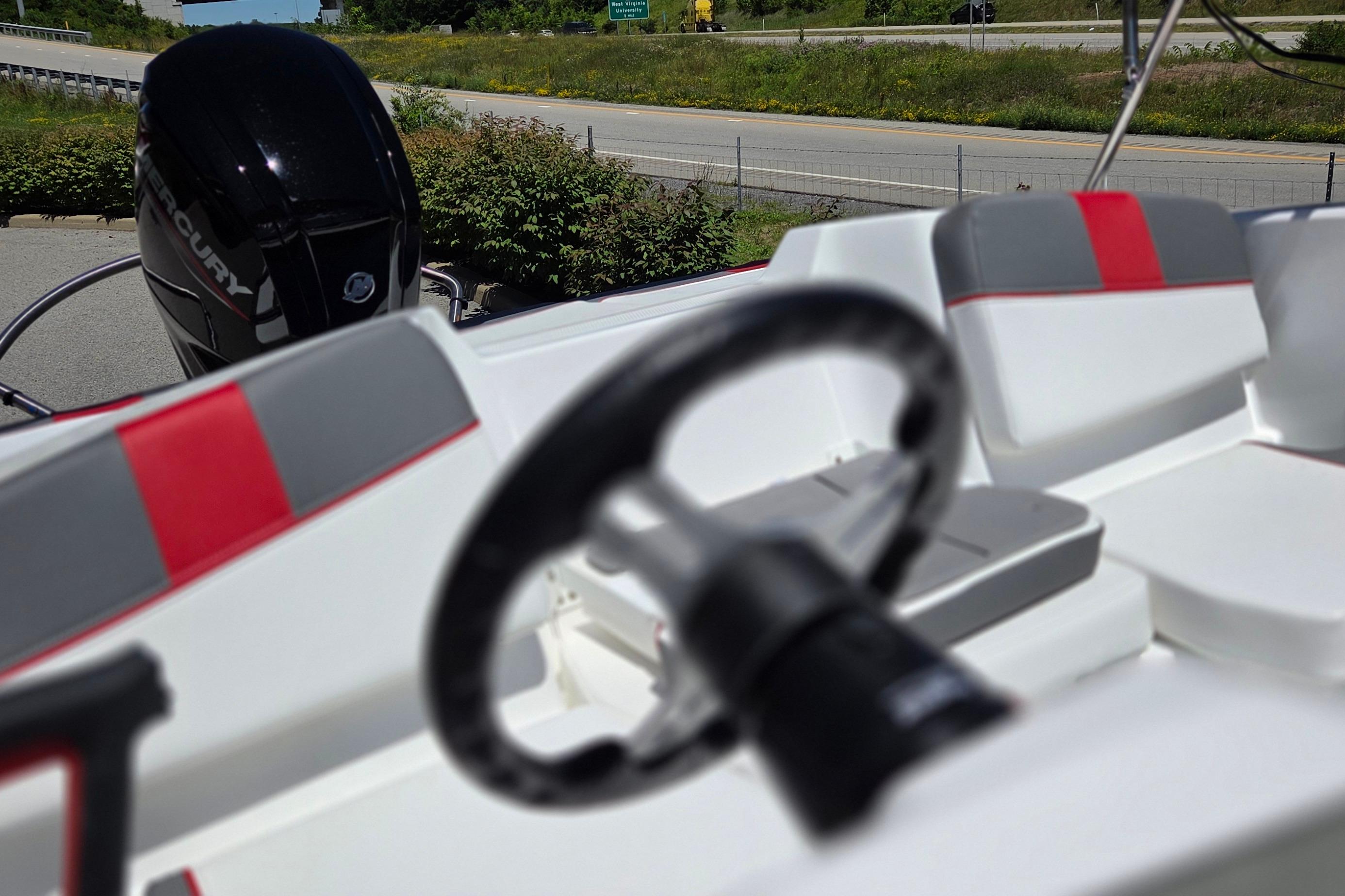 2026 Tahoe T16 boat interior with steering wheel and Mercury engine.