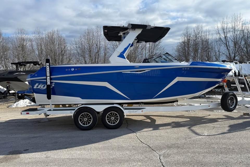 2026 Tigé Z3 boat in blue on a trailer, parked outdoors.