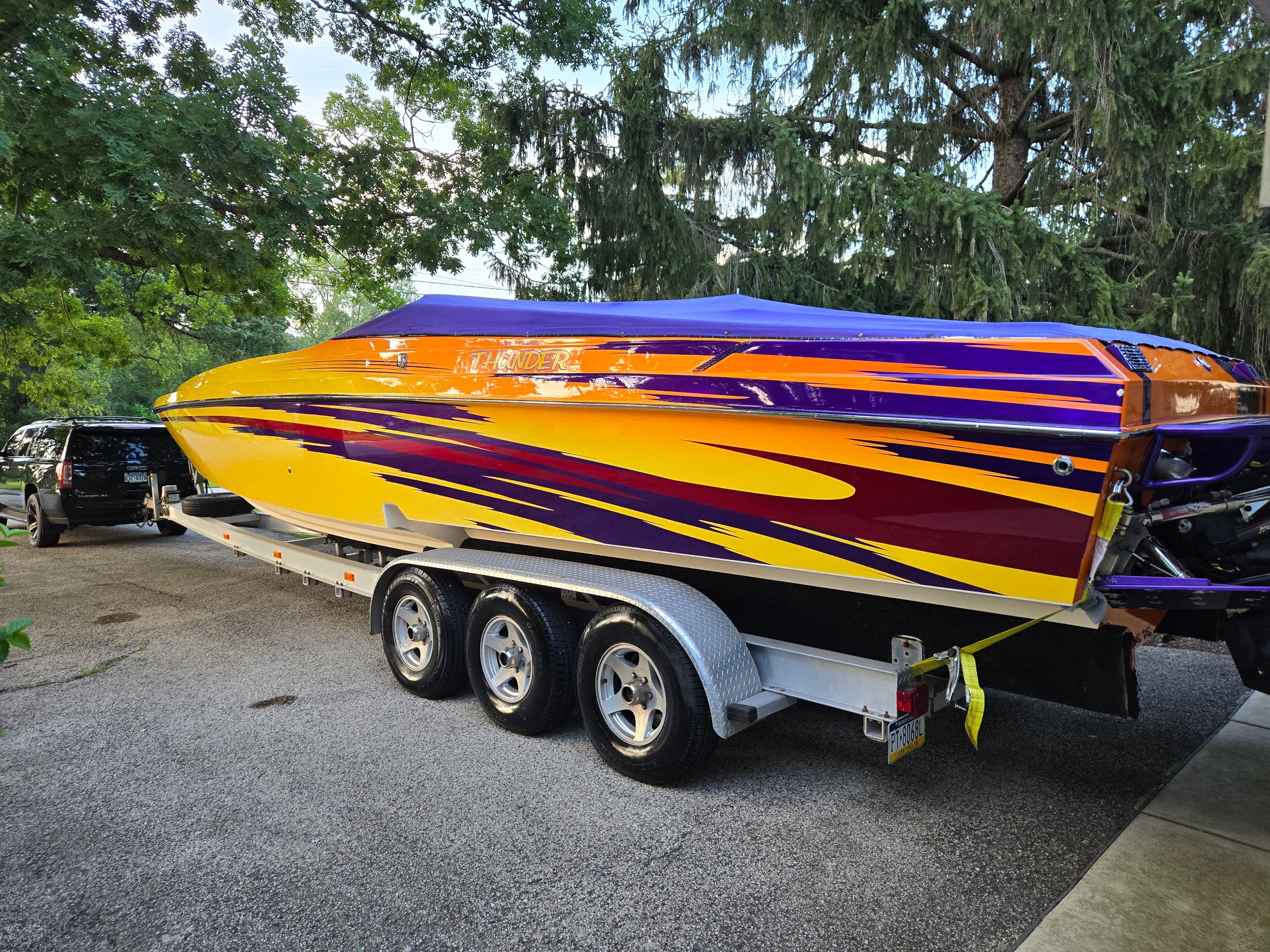 2006 Active Thunder Offshore boat on trailer, vibrant paint design.
