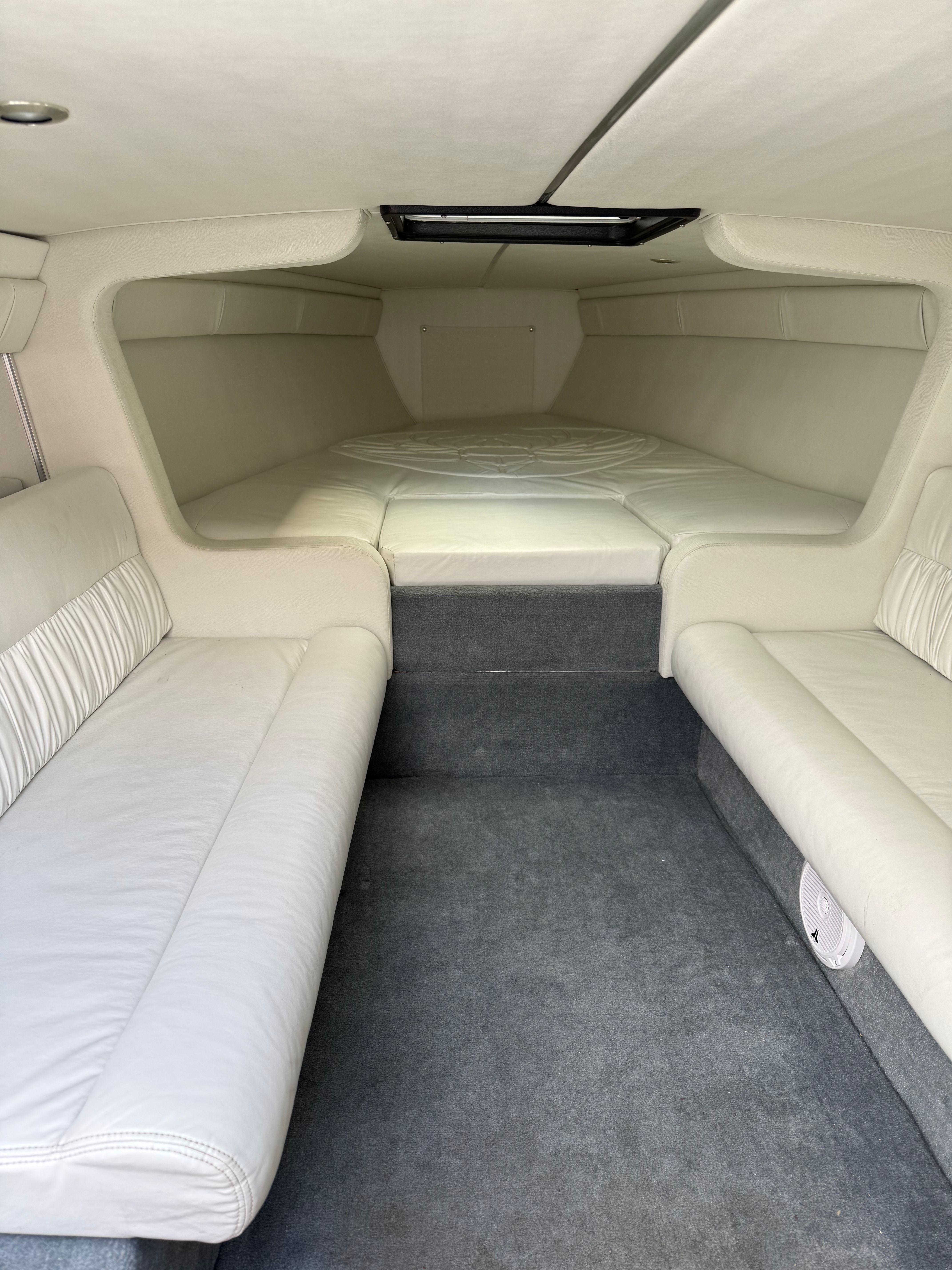 Interior of a 2001 Wellcraft 29 Scarab with white upholstery.