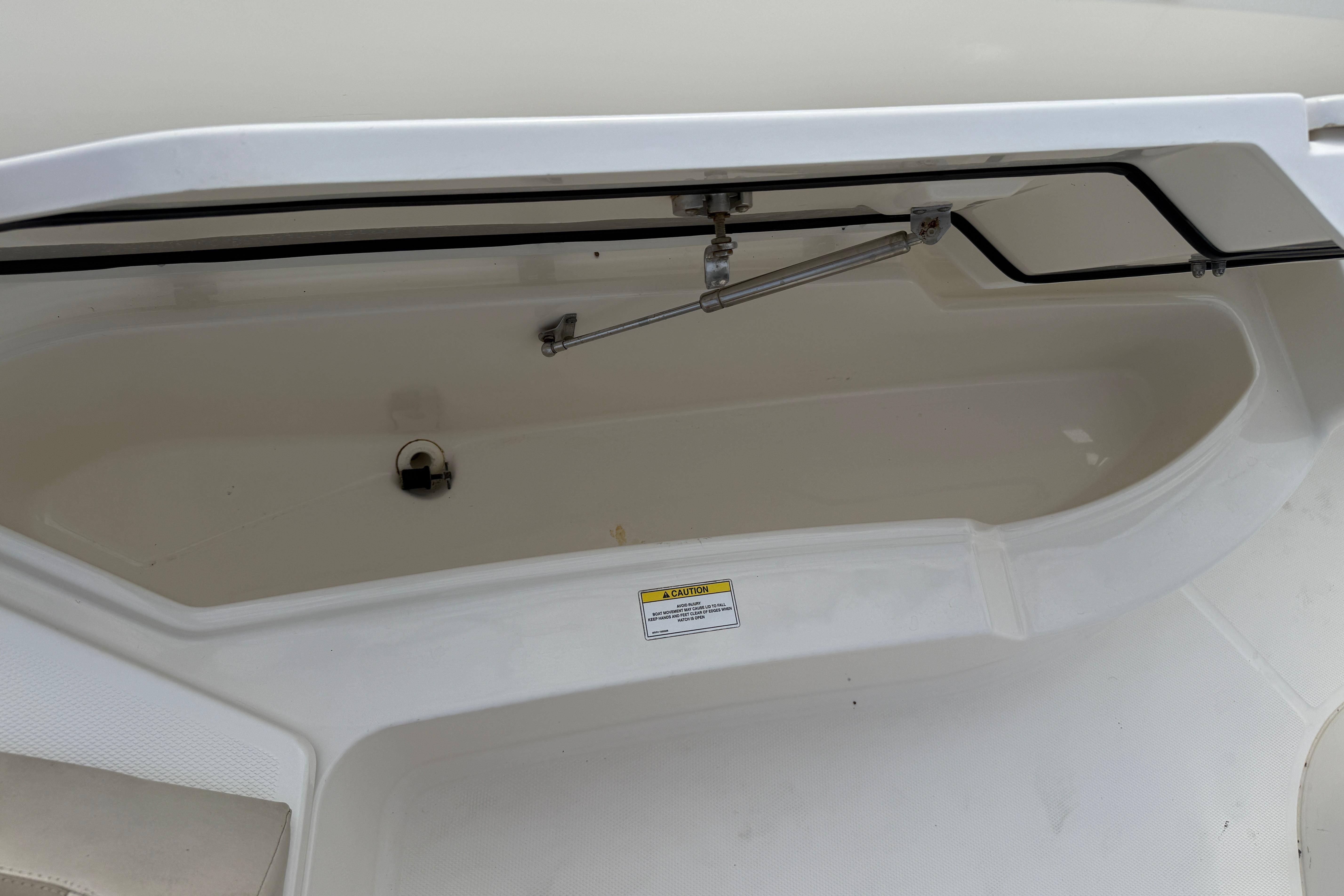 Open storage compartment on a 2018 Boston Whaler 270 Dauntless boat.