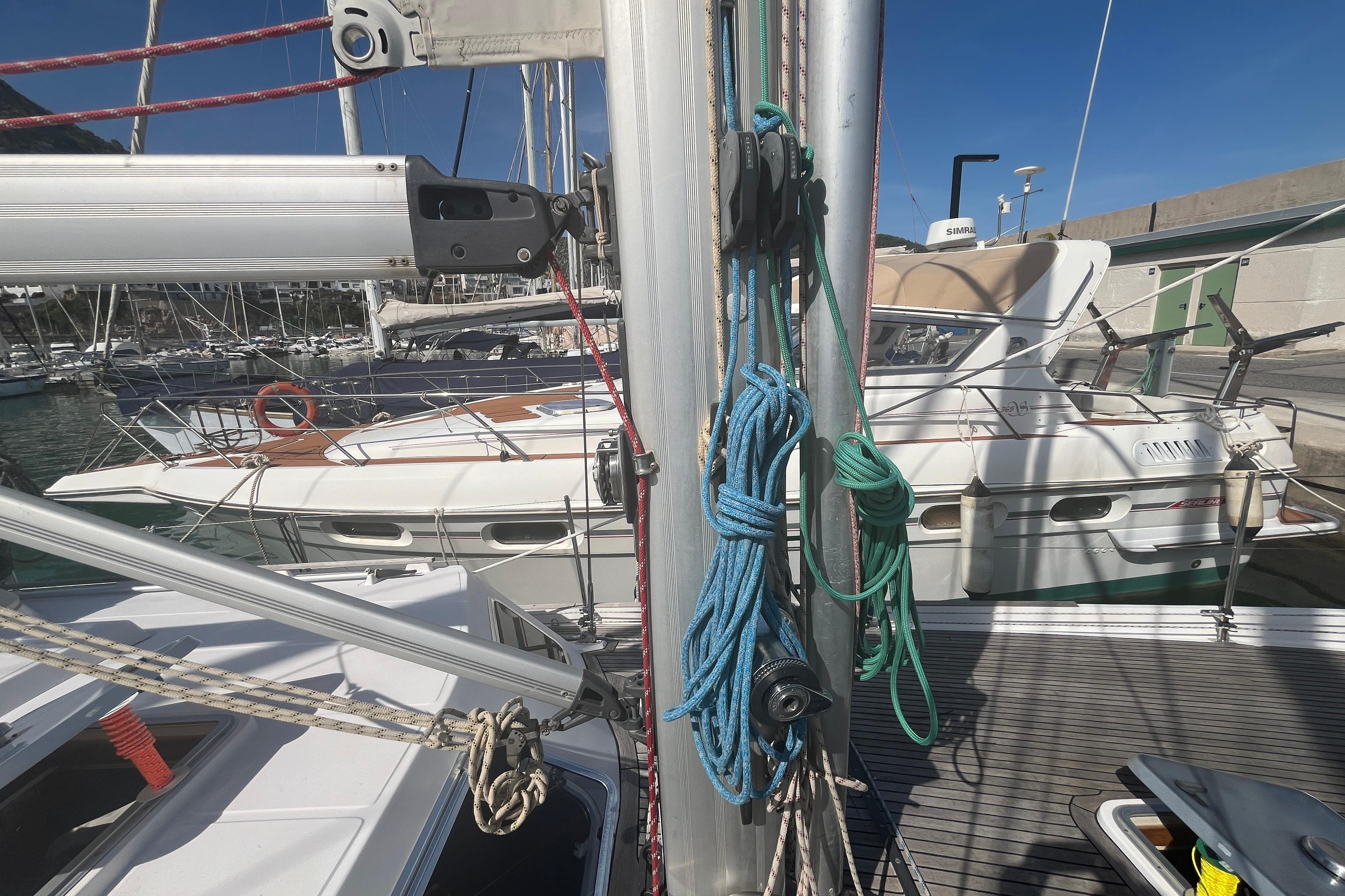 Sailboat docked at marina, featuring ropes and mast, Belliure 41, 1995 model.