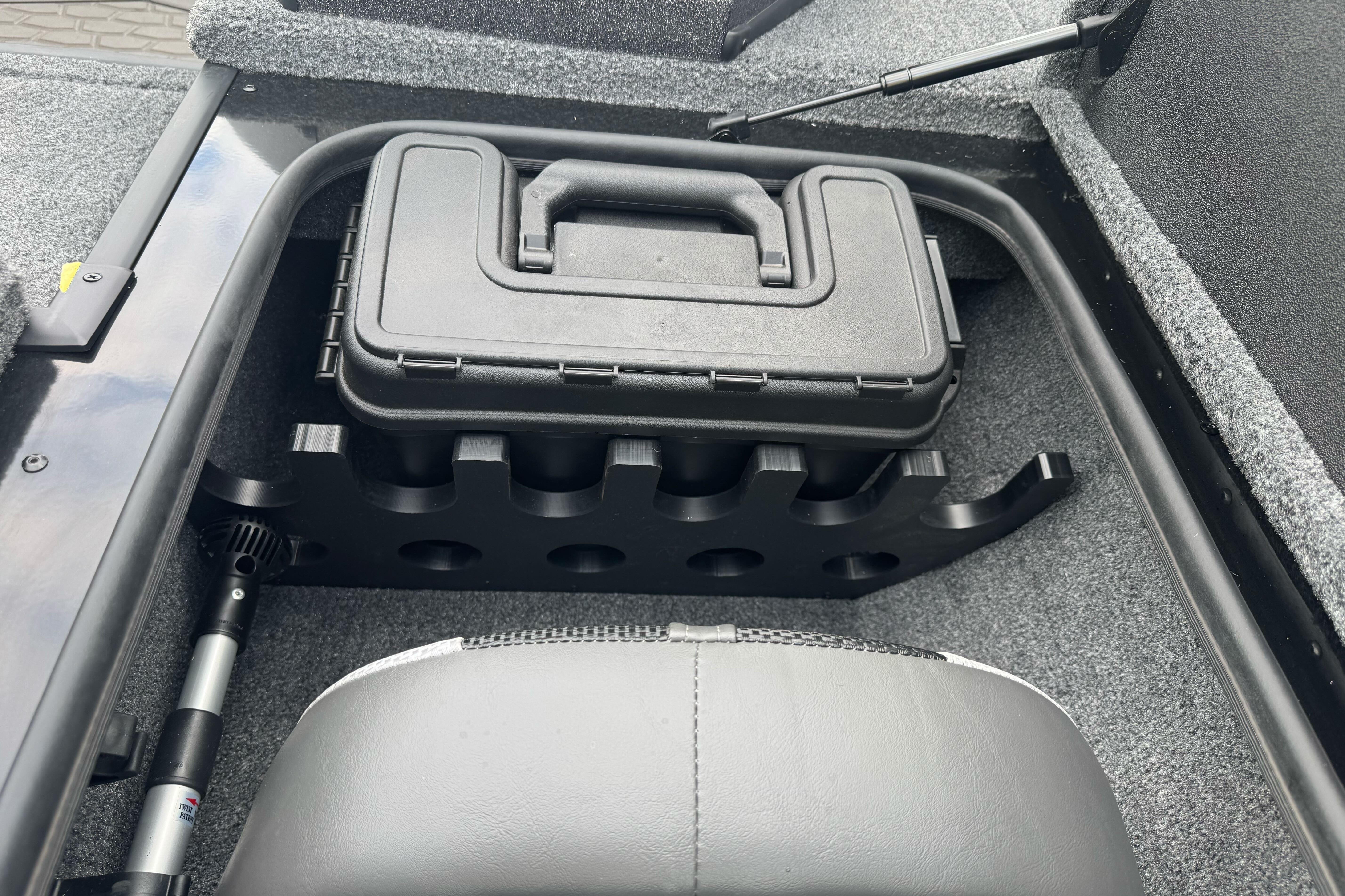 Storage compartment in 2026 Ranger ALPHA 208 boat, featuring a secure black case.