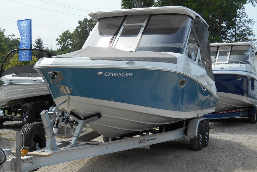 2024 Finseeker 280 DC boat on trailer, displayed outdoors.