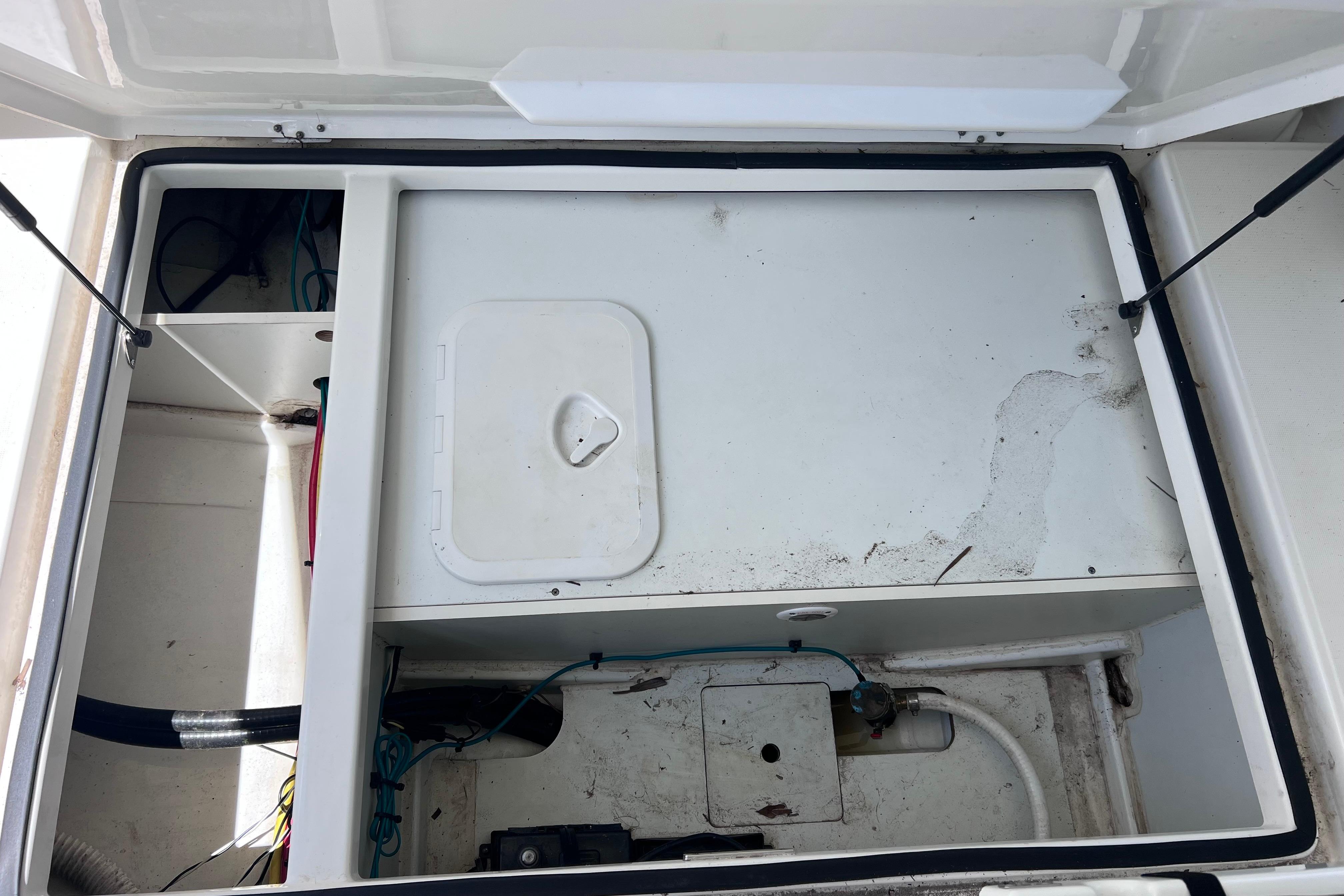 Open storage compartment in a 2021 Jeanneau NC Weekender 795 Series 2 boat.