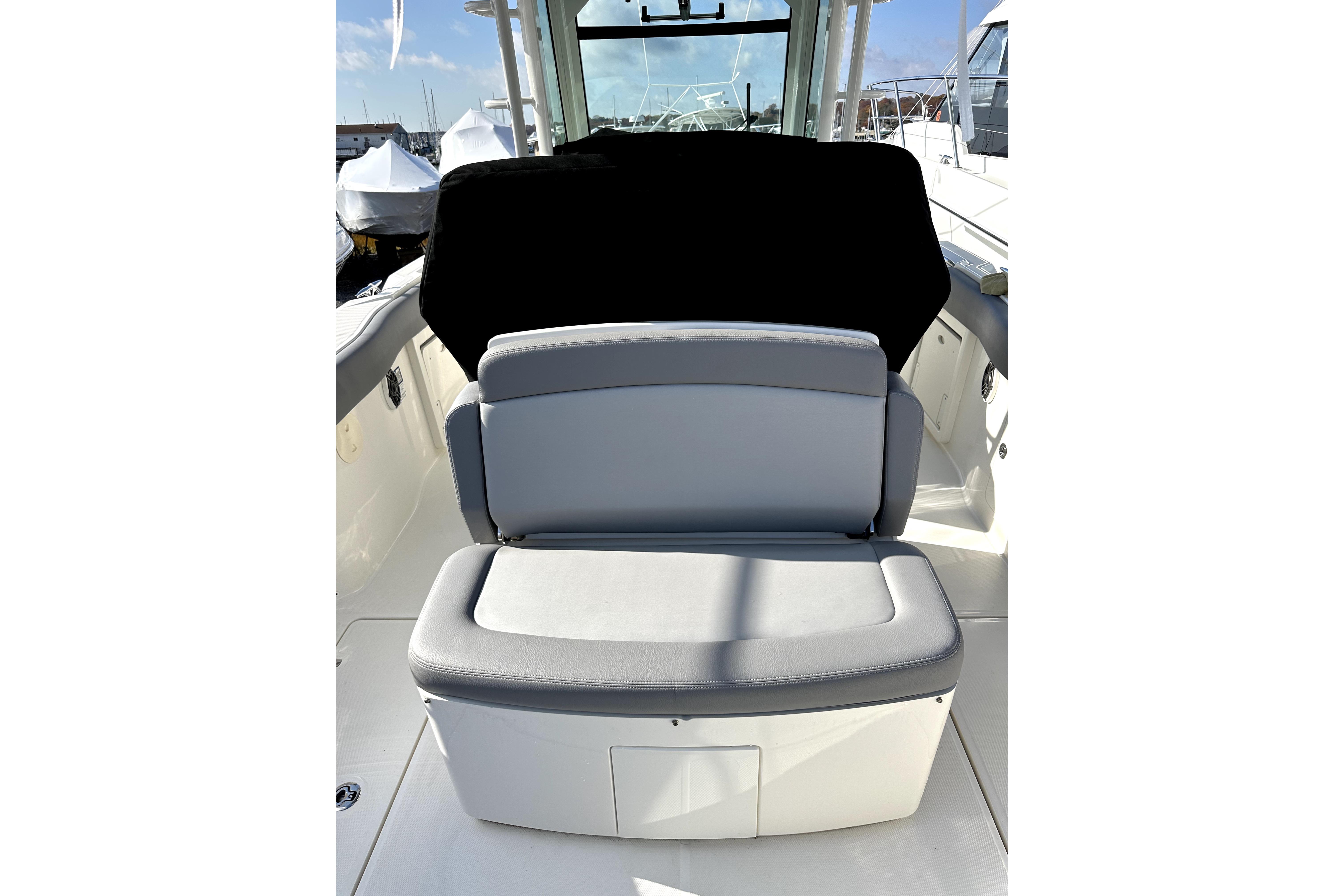 2023 Boston Whaler OUTRAGE boat interior with cushioned seating and sleek design.