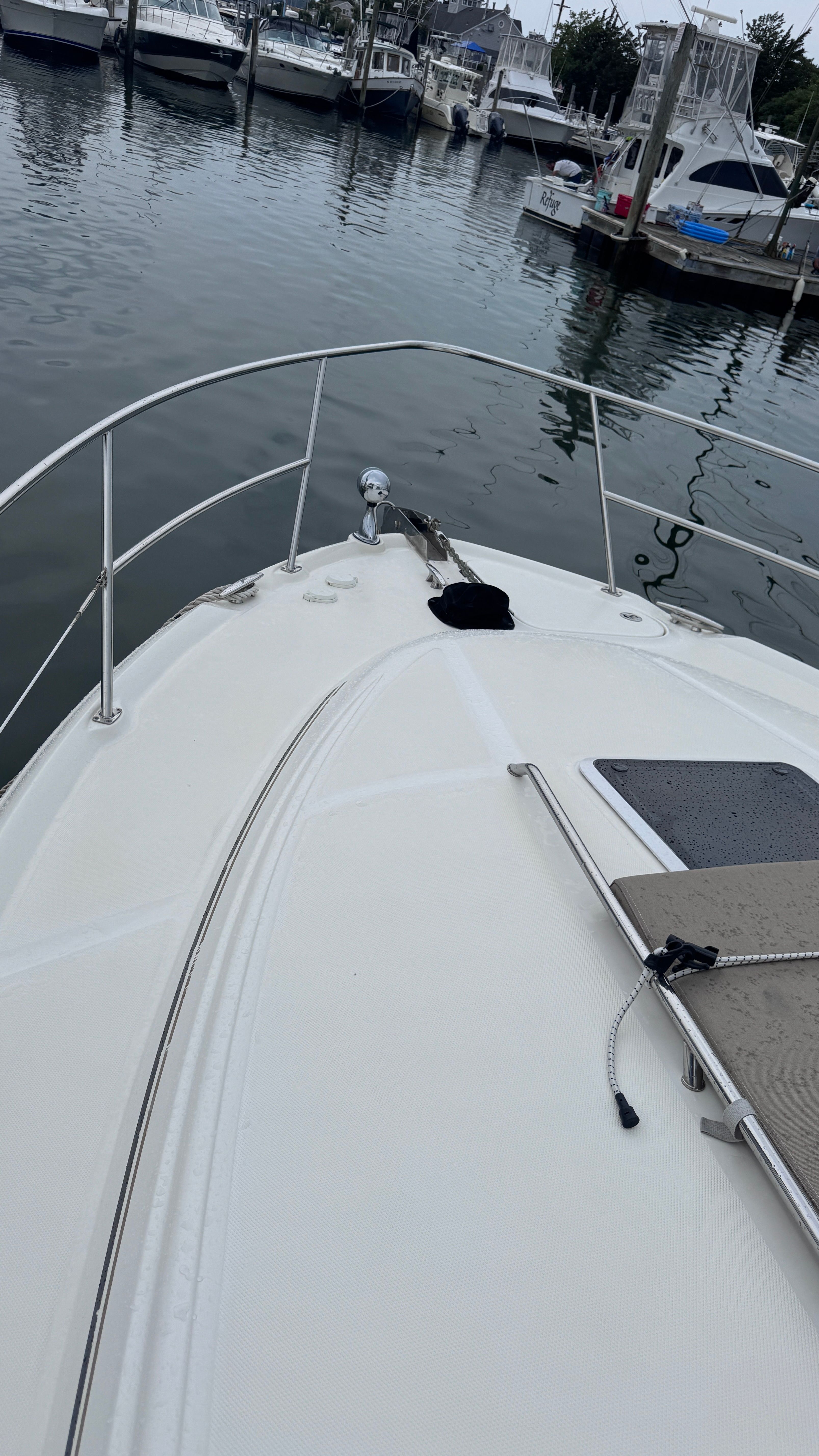 The image shows the bow of a 2003 Sea Ray 360 Sundancer docked in a marina.