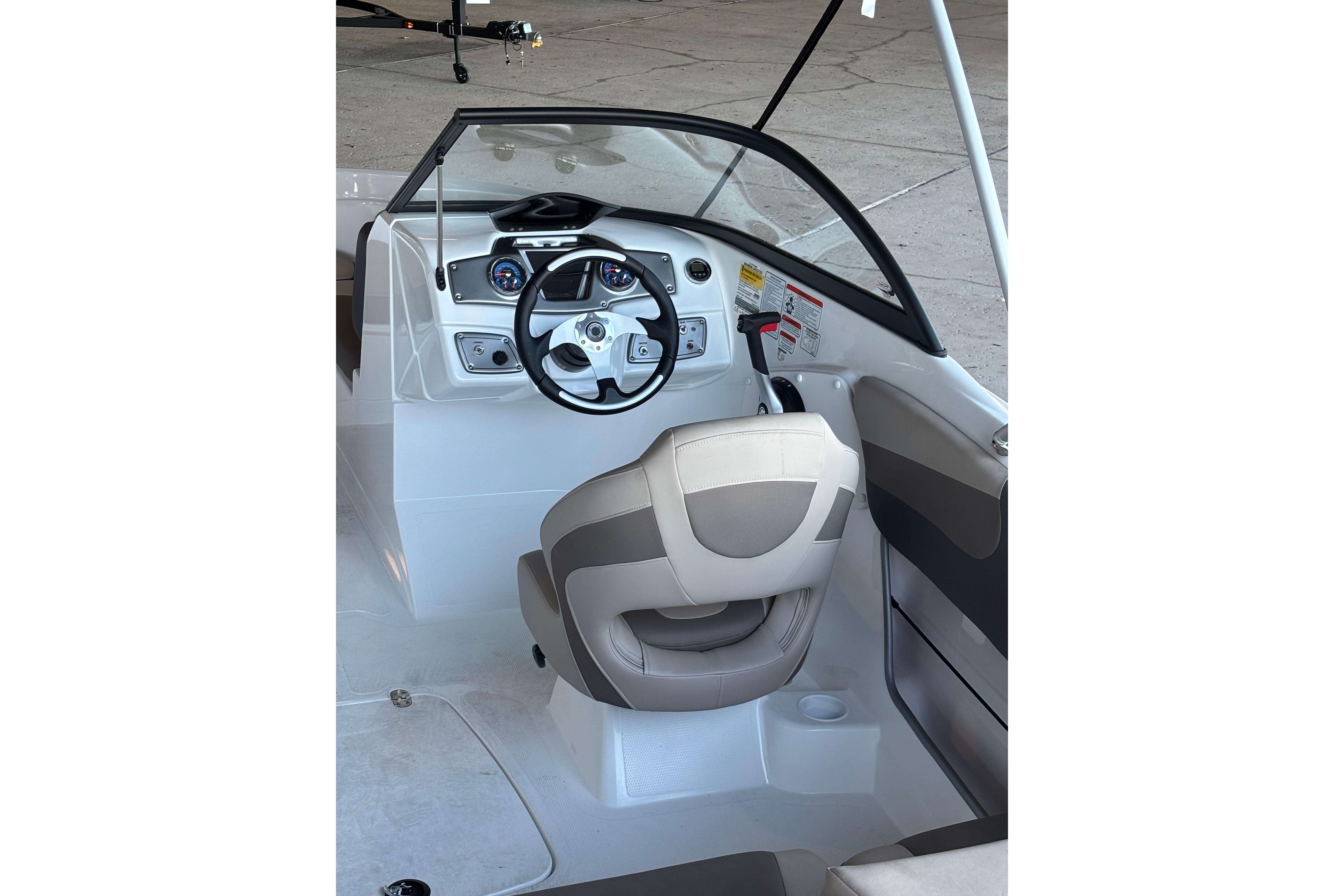 Interior view of 2025 Tahoe 200 S boat cockpit with steering wheel and dashboard.