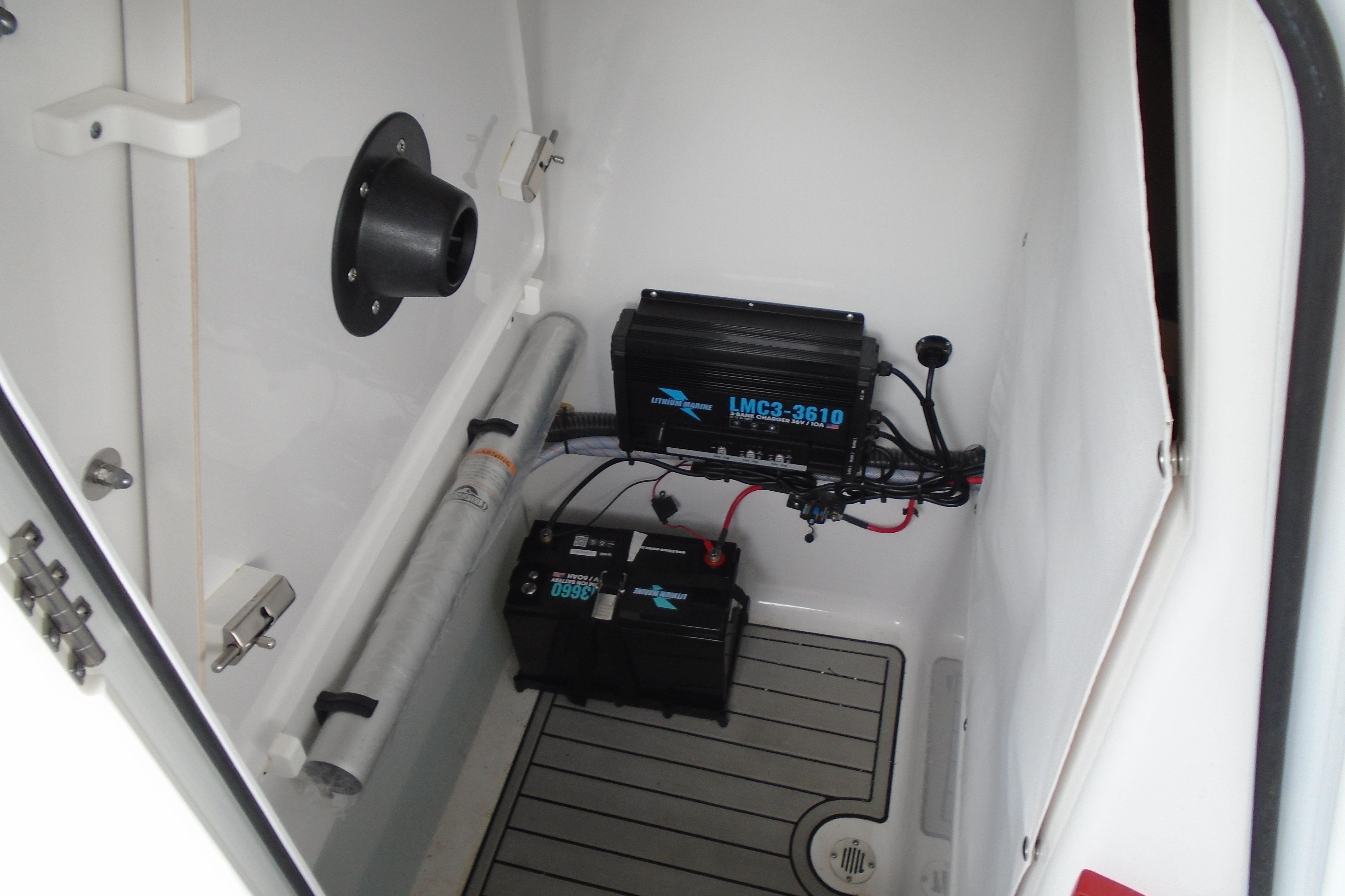 Interior of 2022 Sportsman Heritage 241 Center Console showing electrical components and storage.