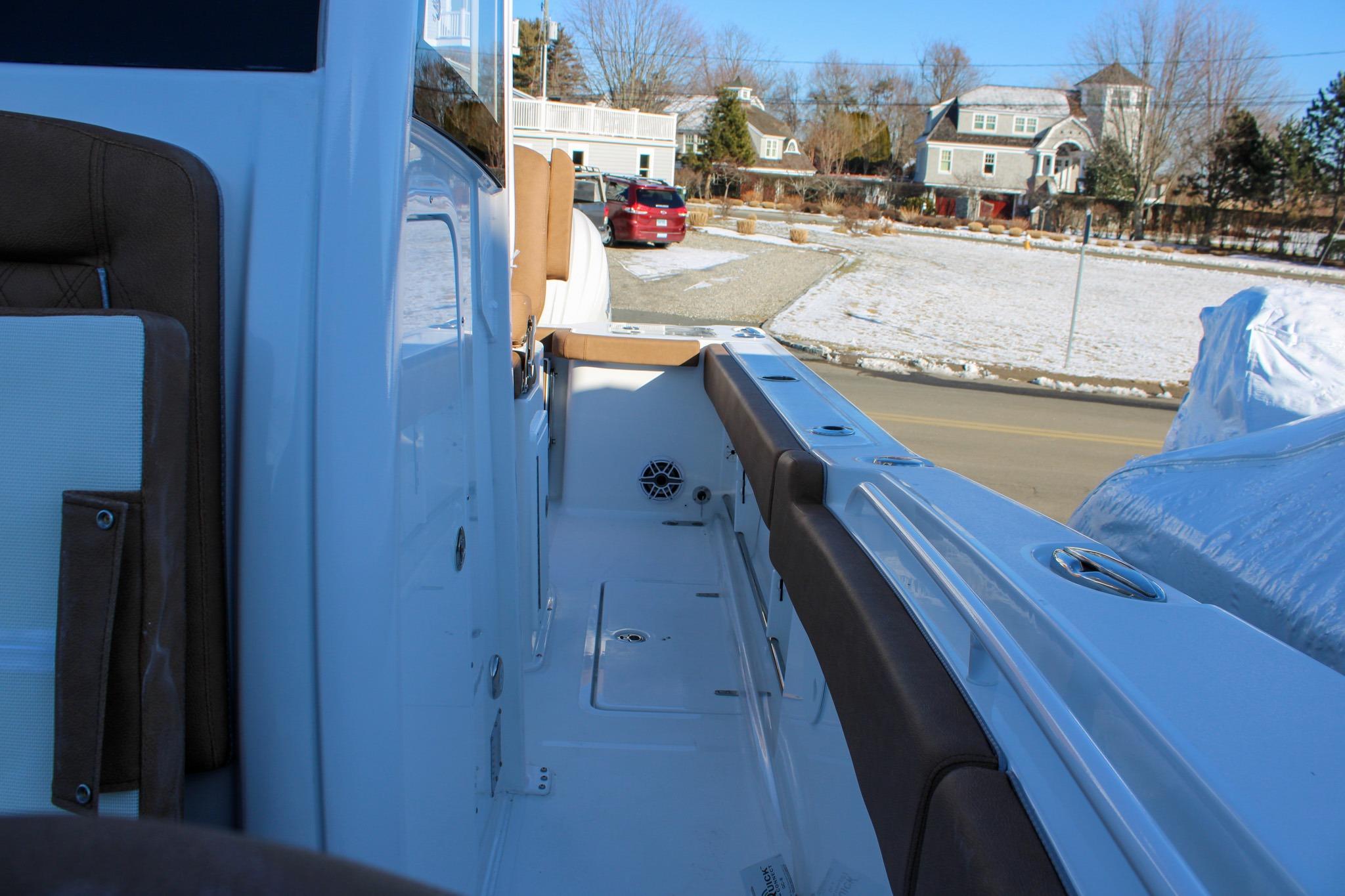2026 Sea Hunt Gamefish 25 boat interior with brown seating and snowy background.