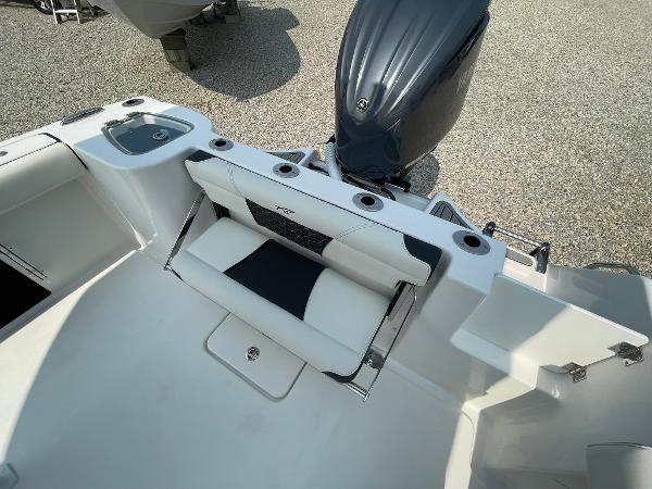 2025 Tidewater 232 CC Adventure boat interior with seating and motor.