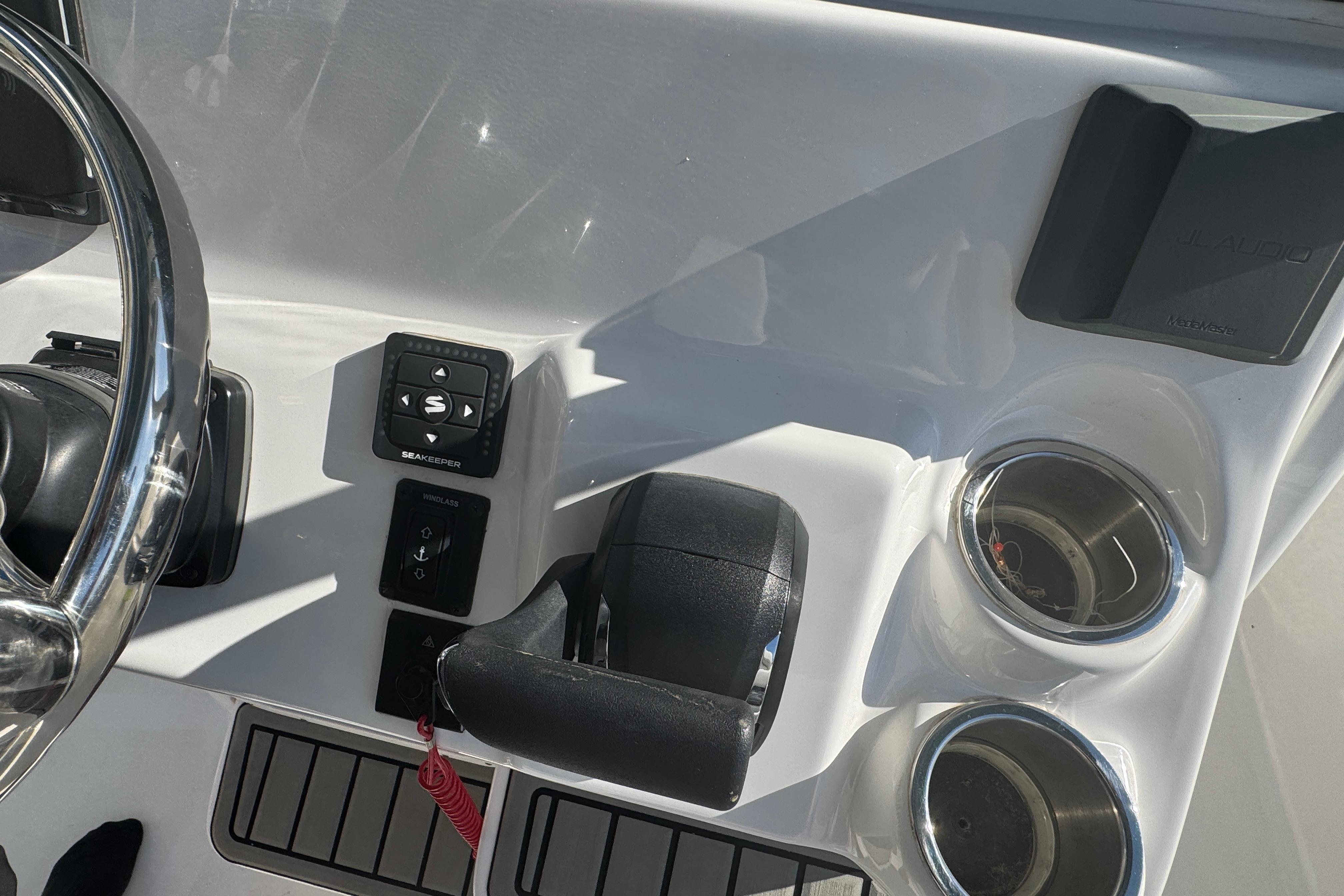 Helm of 2025 Tidewater 232 LXF boat with controls and cup holders.