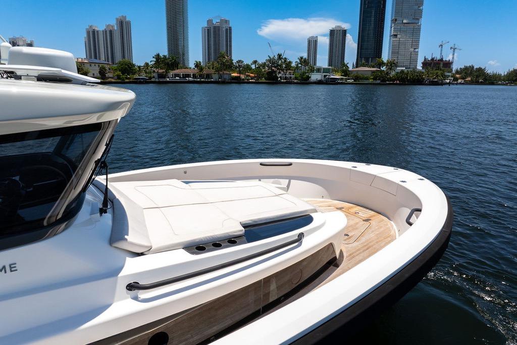 2021 Bluegame BG 42 yacht on water with city skyline backdrop.