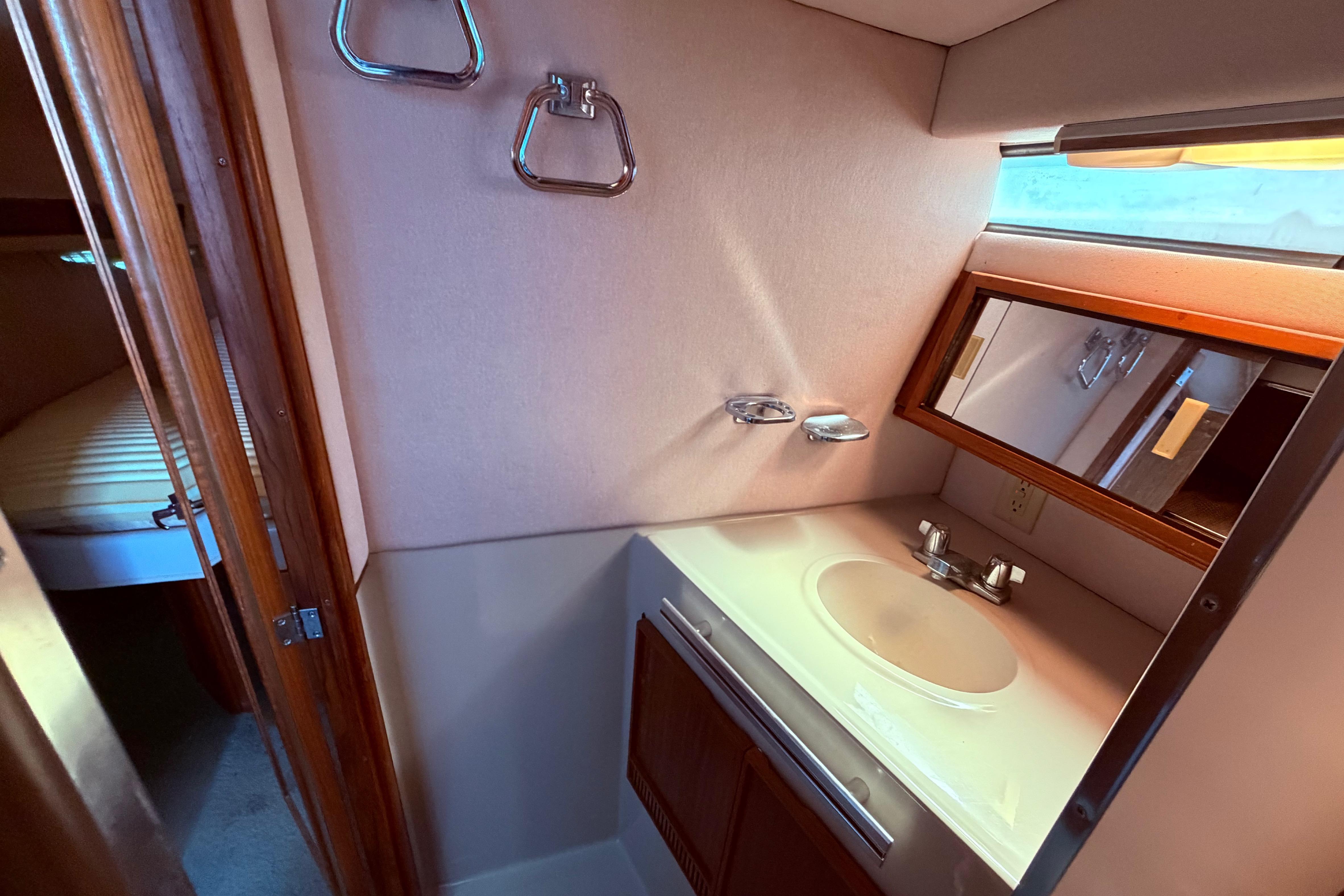 1987 Sea Ray 340 Sedan Bridge bathroom vanity, view from the shower