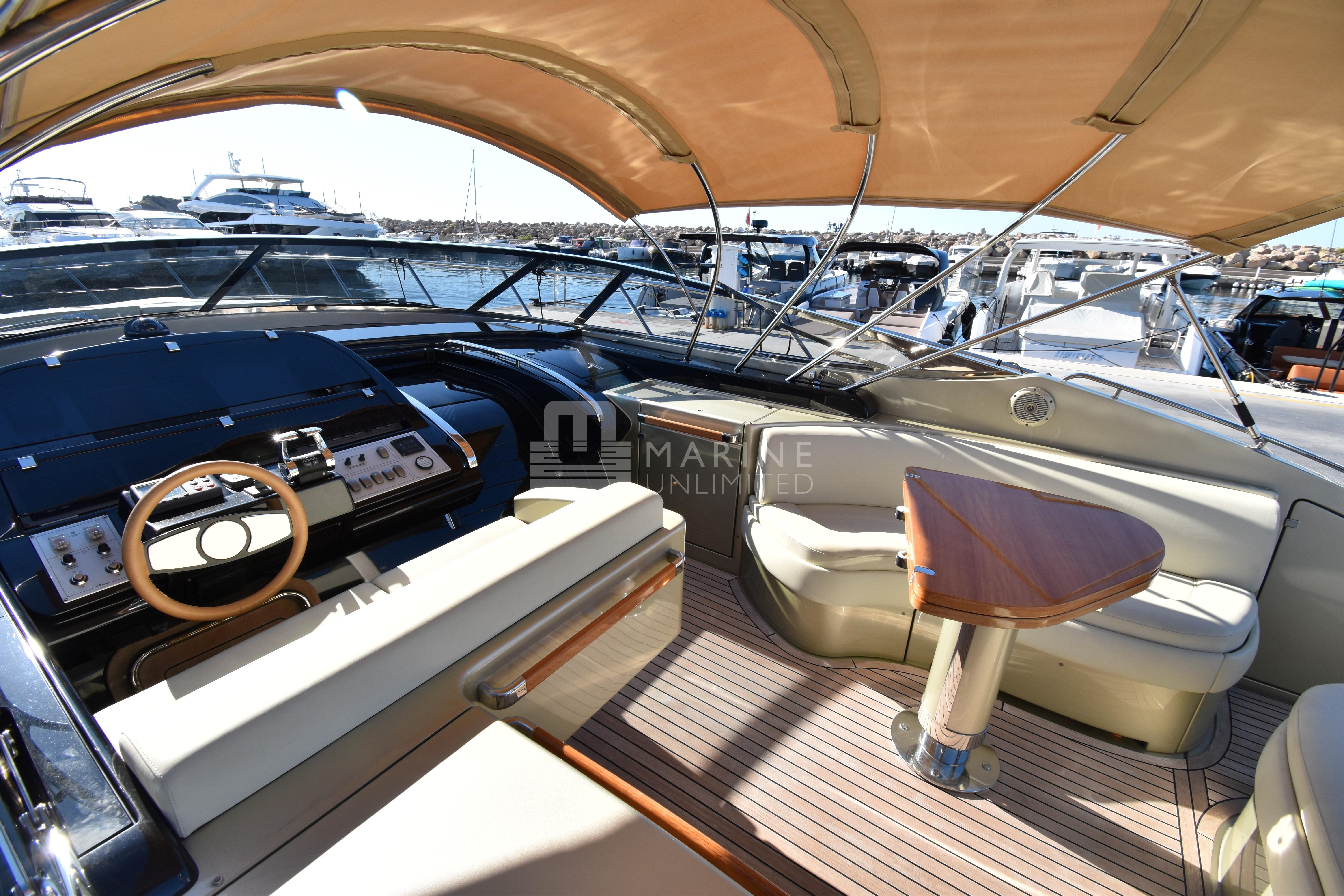 Luxurious 2010 Riva 52' Rivale yacht interior with helm and seating area.