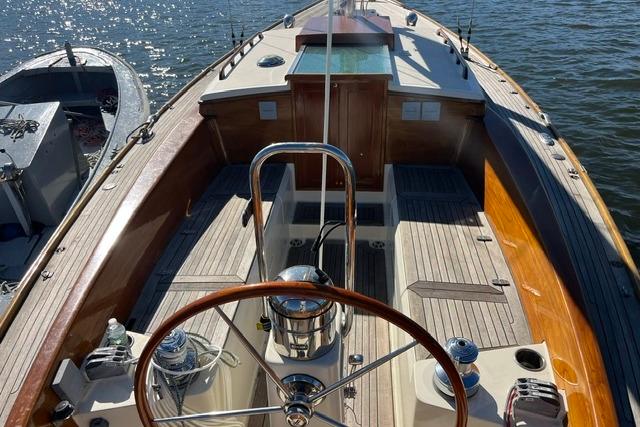 2006 Morris 36 sailboat cockpit with wooden accents and steering wheel on calm water.