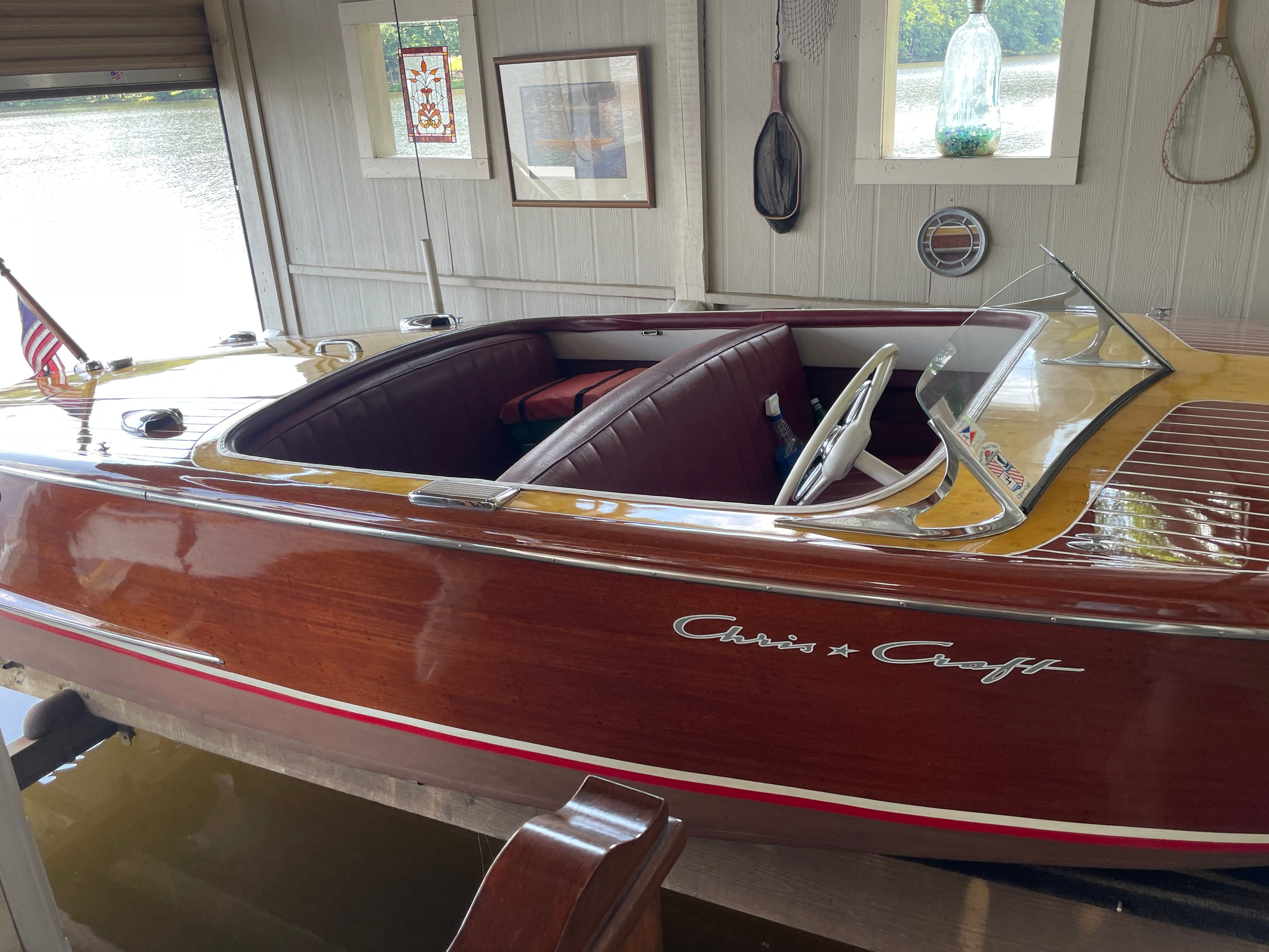 1954 Chris-Craft Riviera wooden boat in a boathouse.