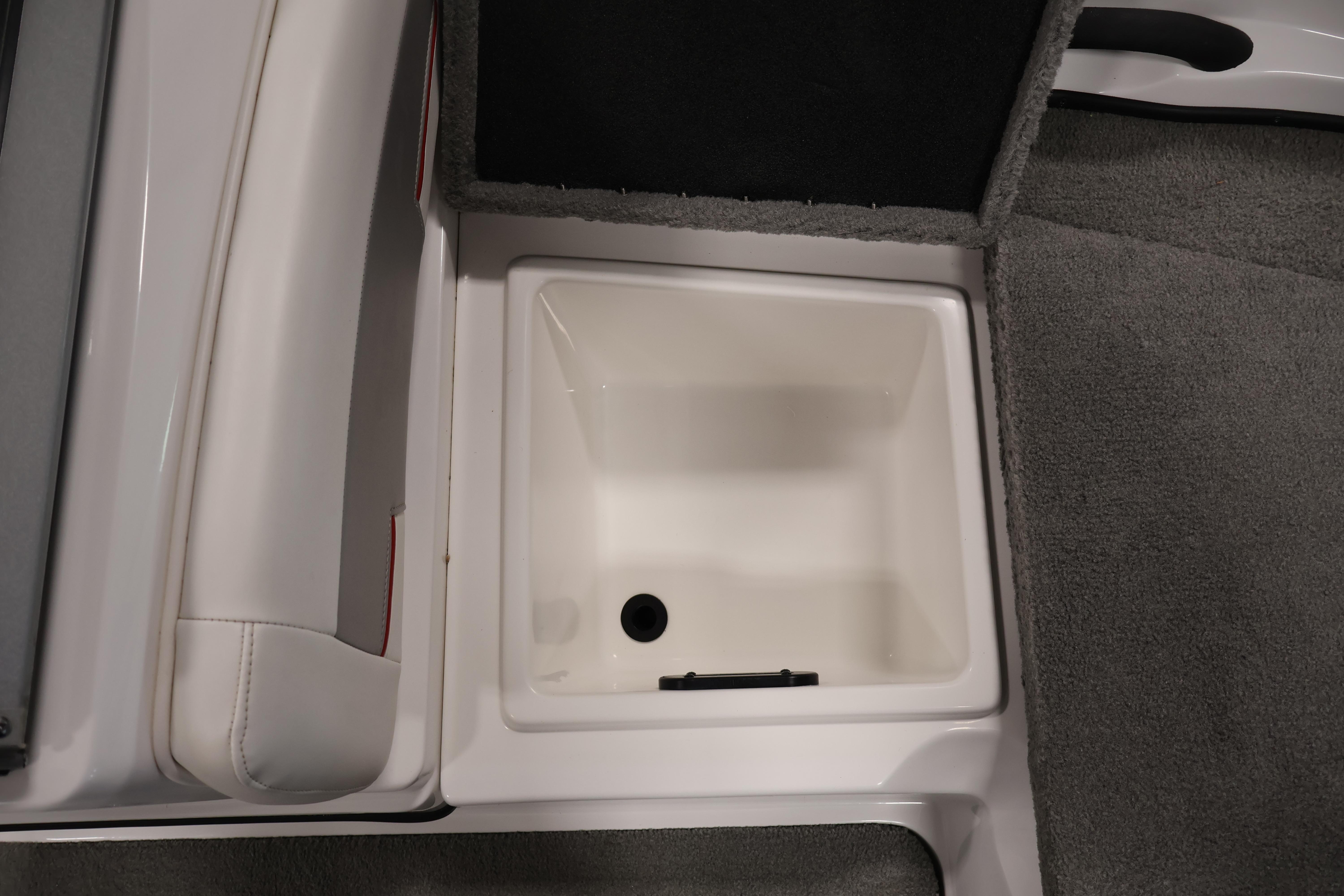 2019 Nitro Z19 Sport boat storage compartment with gray carpet and white interior.