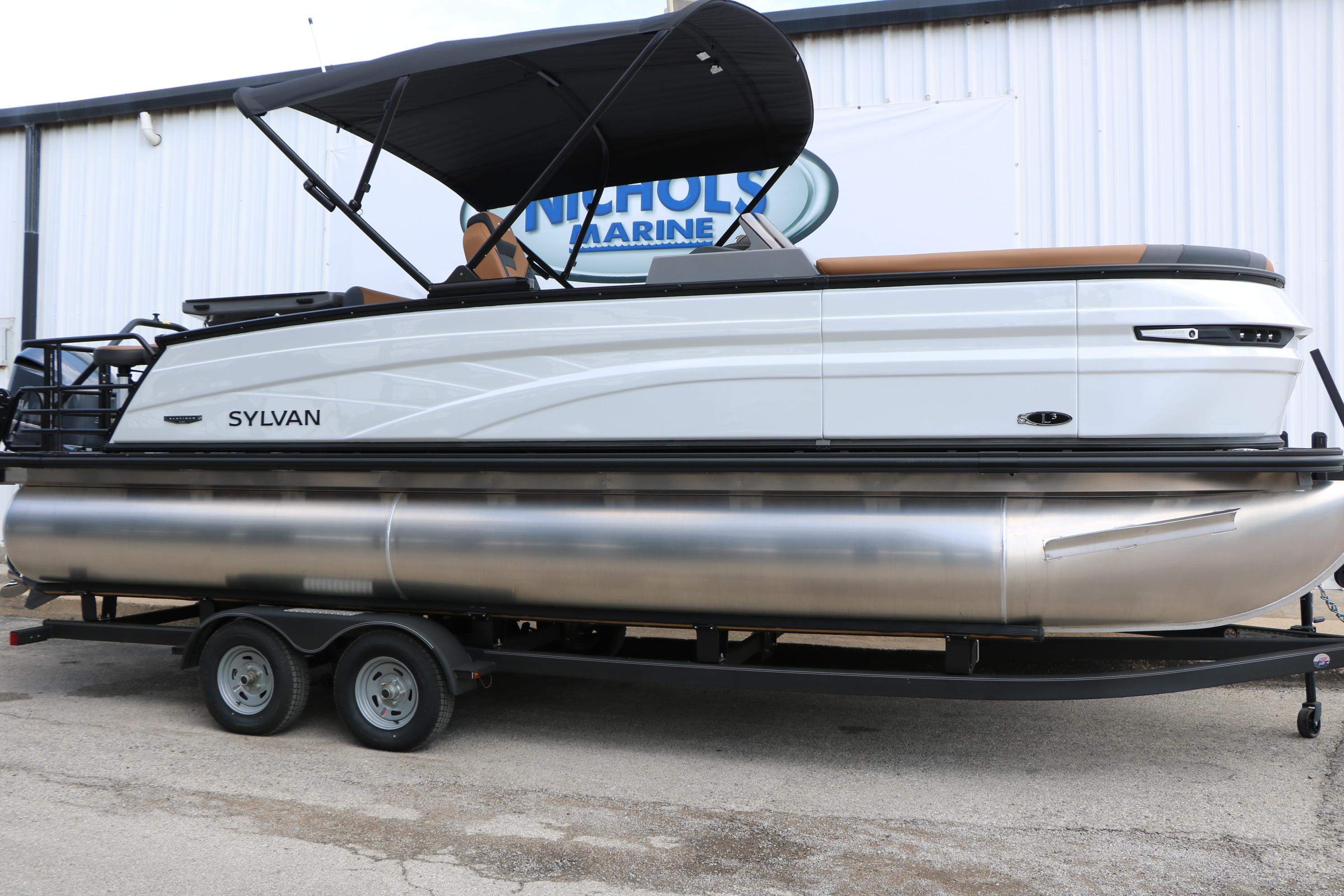 2026 Sylvan L3 DLZ Bar Platinum Edition Tri-Toon boat on trailer, side view.