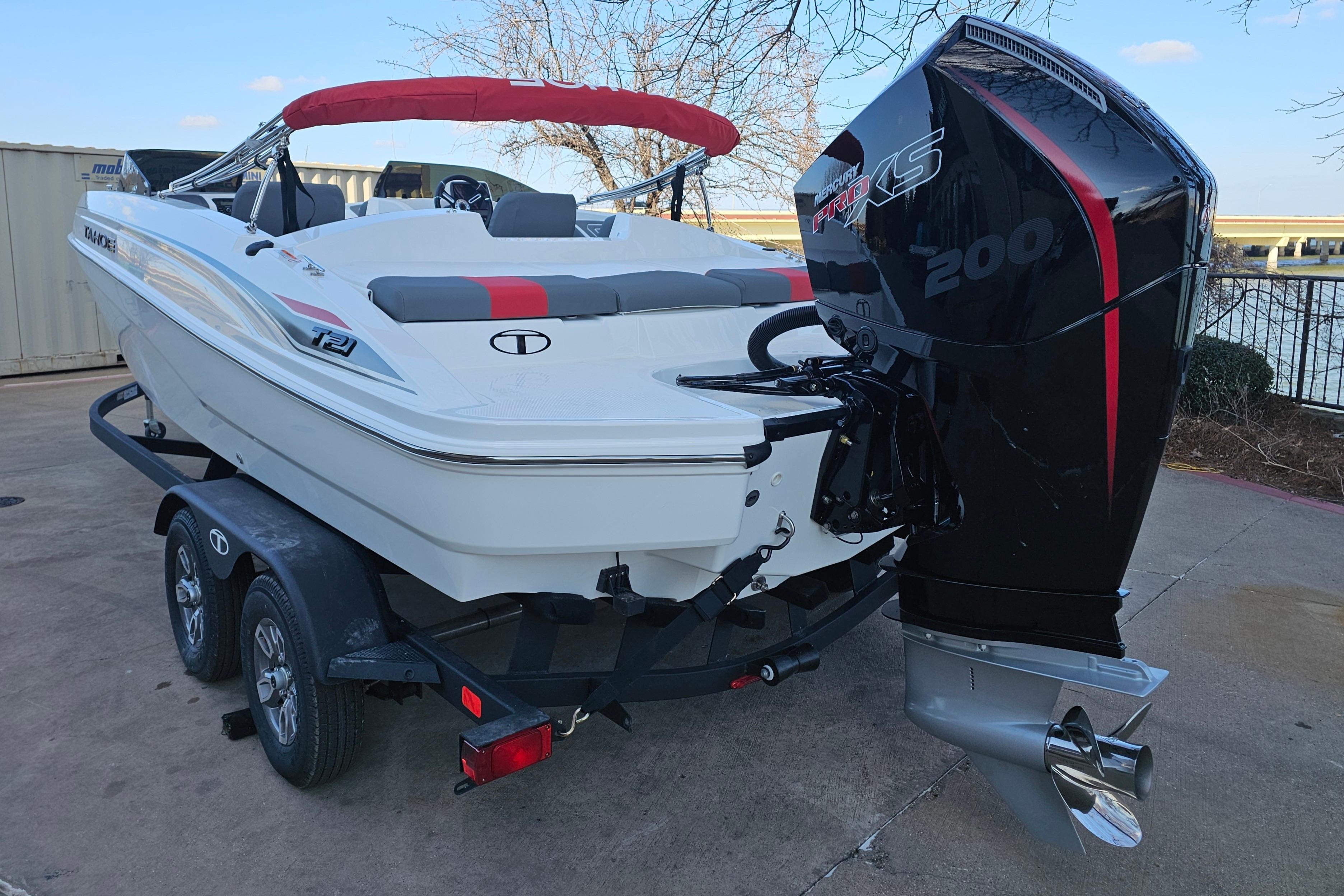 2026 Tahoe T21 boat with outboard motor on trailer.