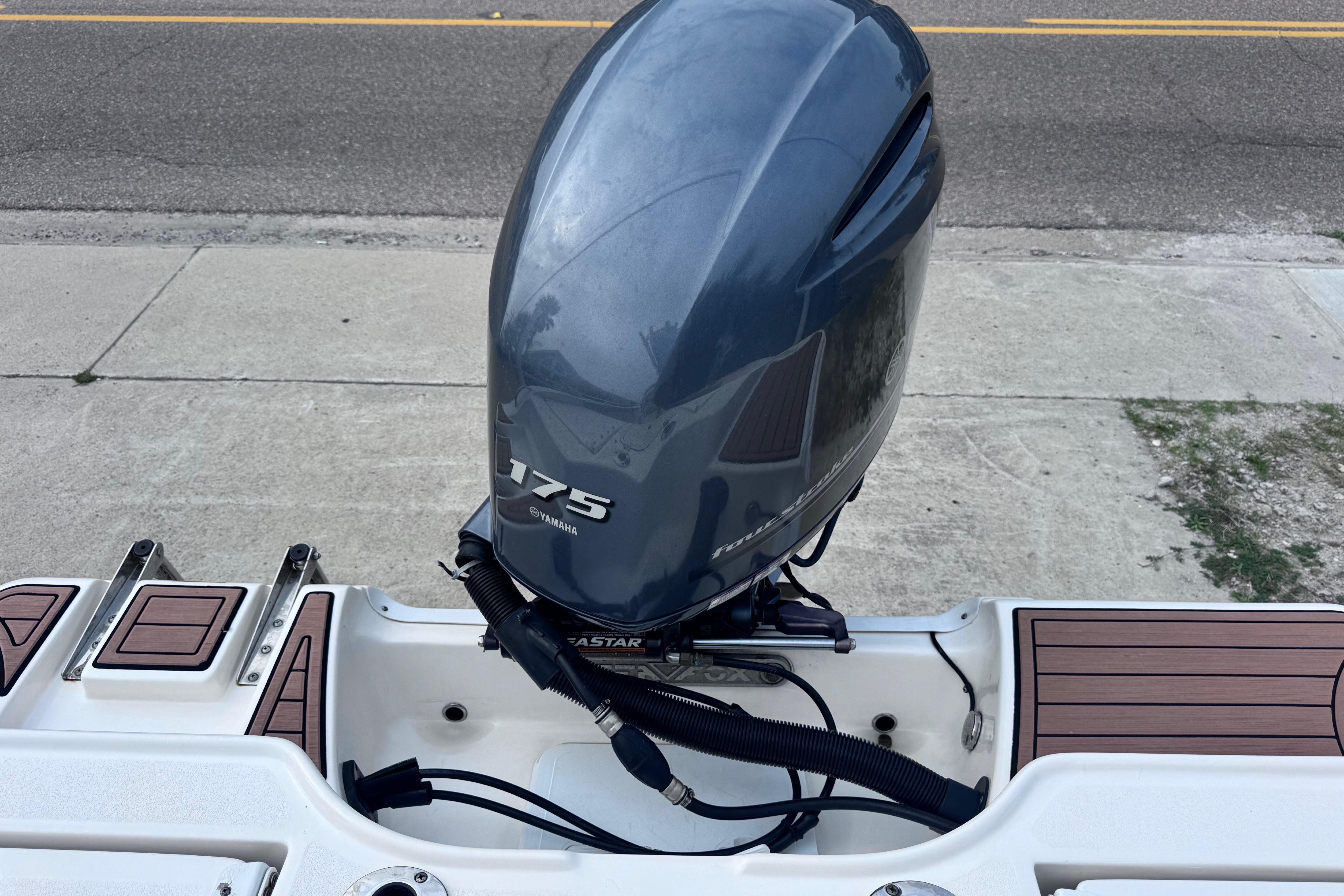 2018 Sea Fox 206 Commander with Yamaha 175 outboard motor, docked on pavement.