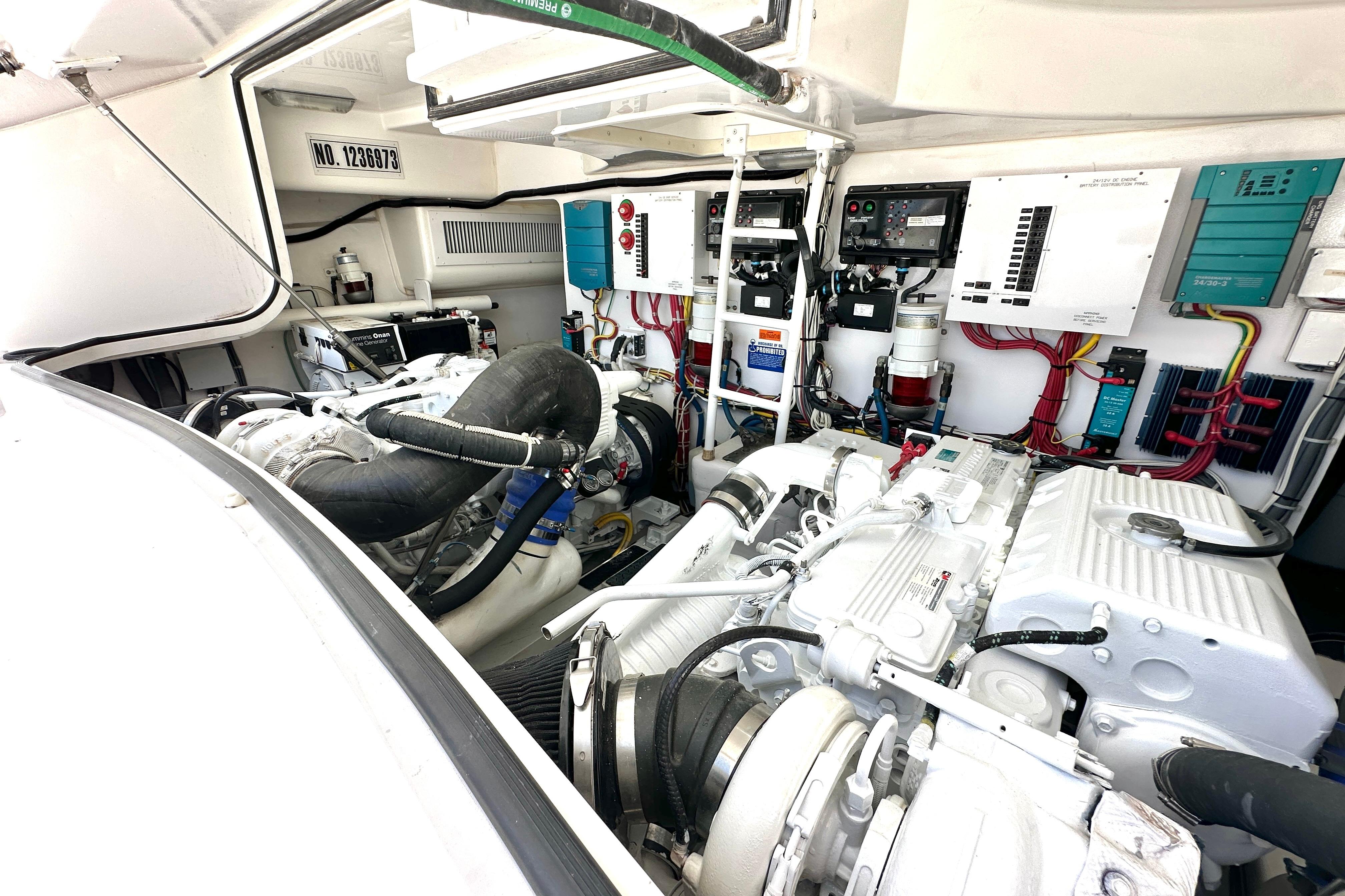Engine room of a 2012 Viking 42 Open yacht, showcasing machinery and wiring.